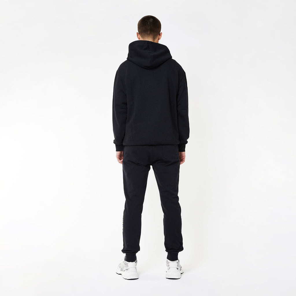 Model wearing BOY London joggers on white background
