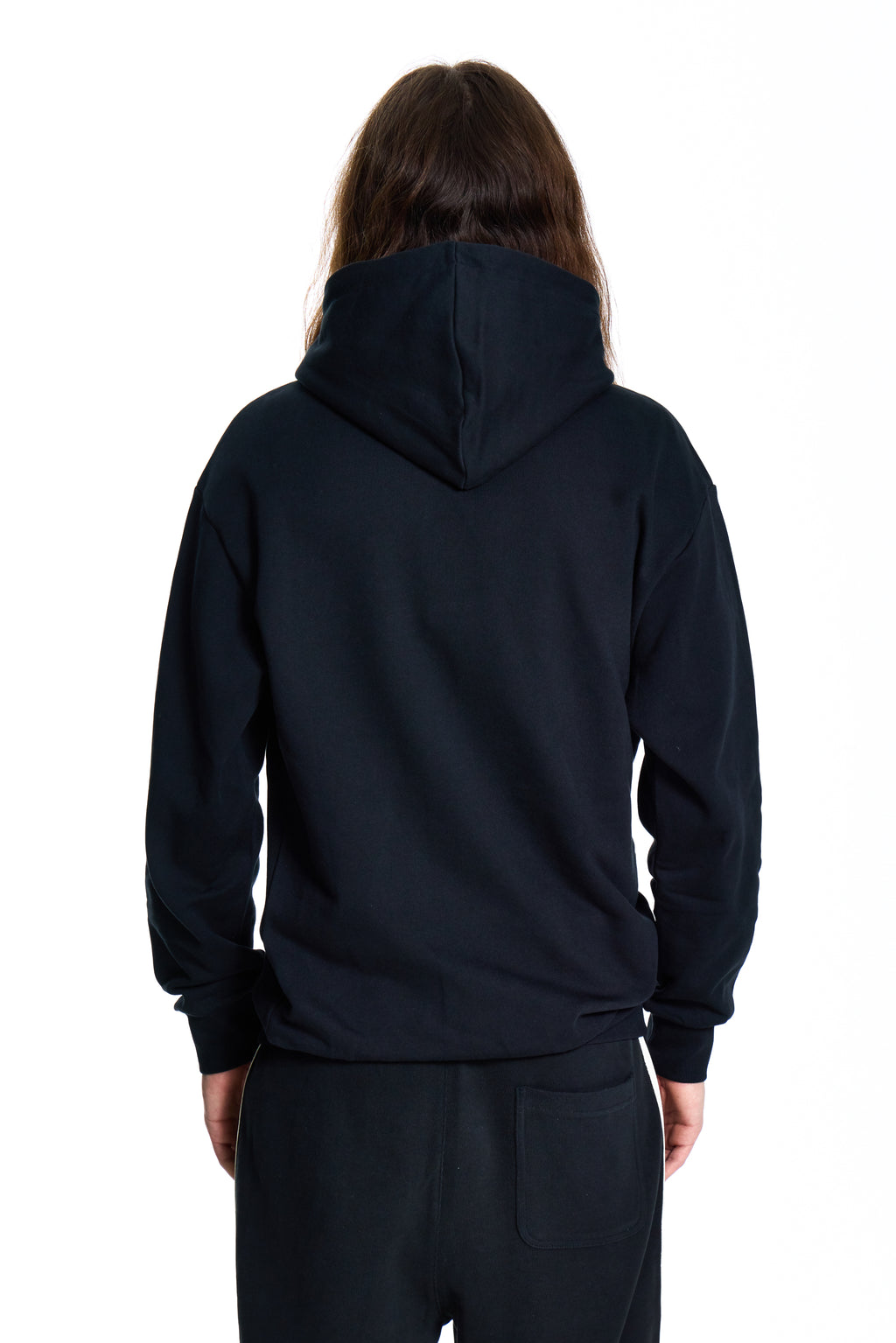Person wearing a black BOY London  hoodie and pants on a white background