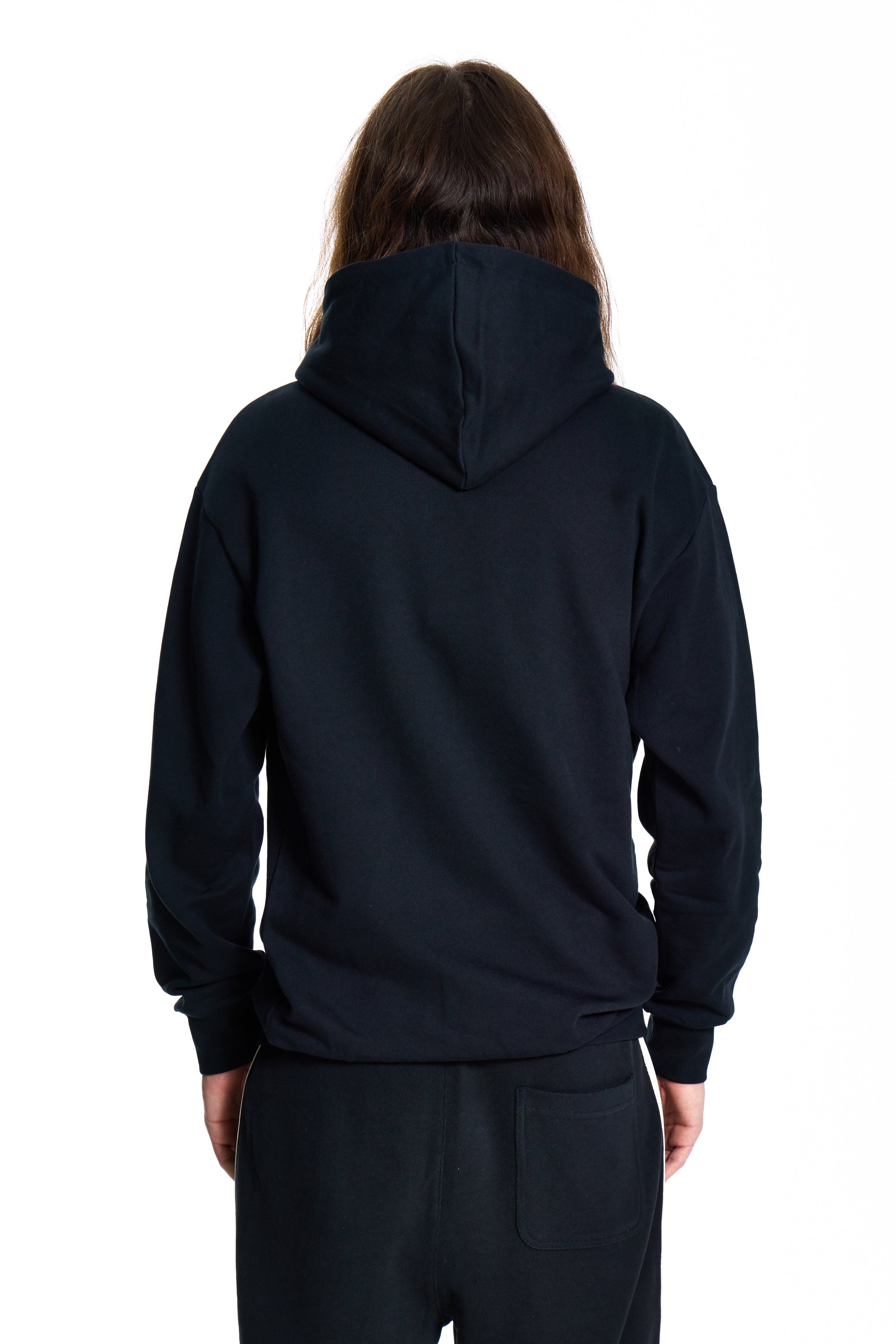 Person wearing a black BOY London  hoodie and pants on a white background