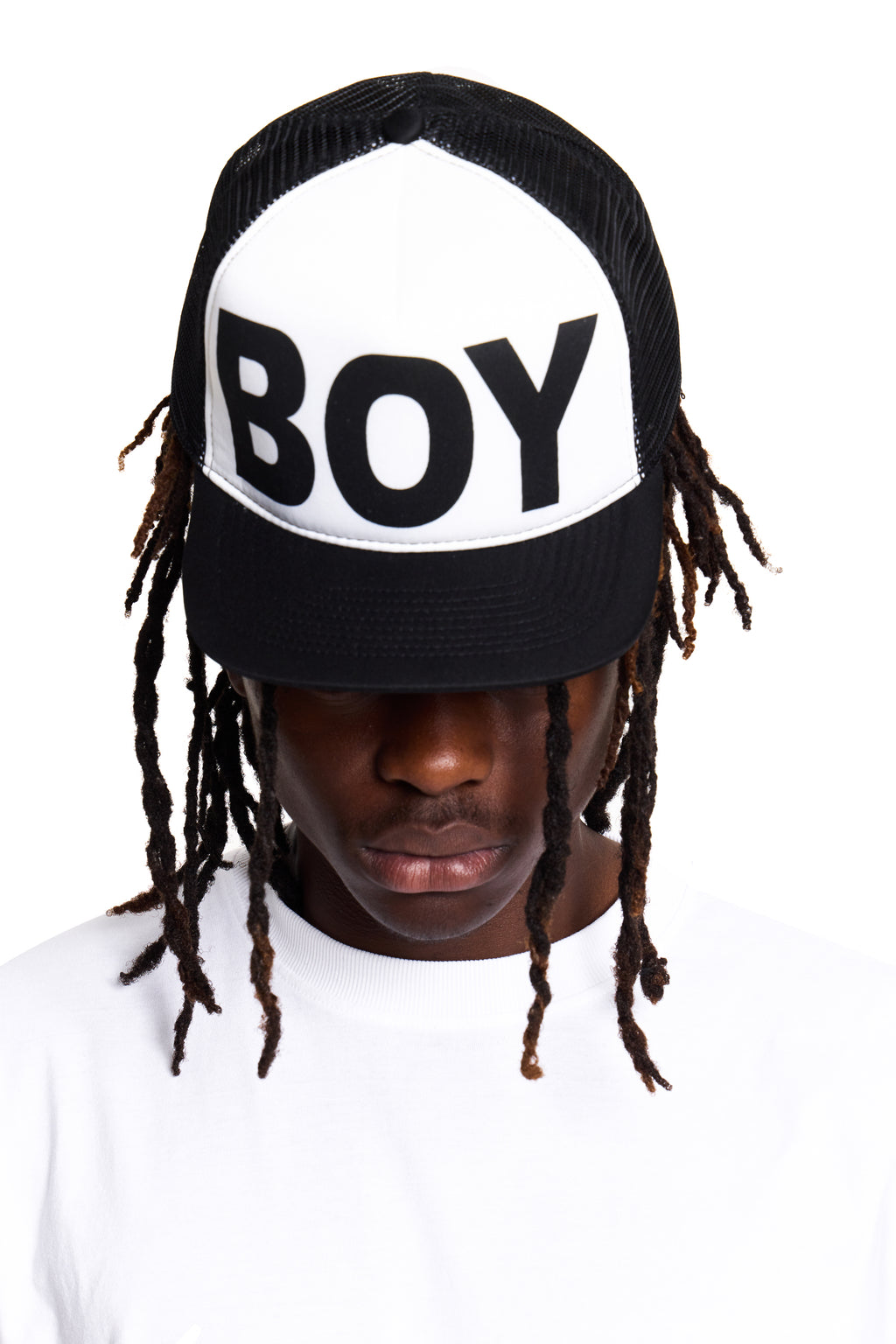 Person wearing a cap with 'BOY' London text on a white background
