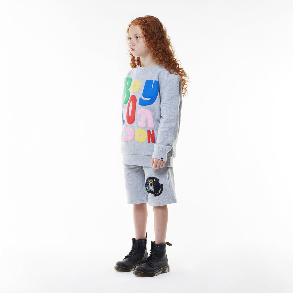 Model wearing BOY London shorts on white background
