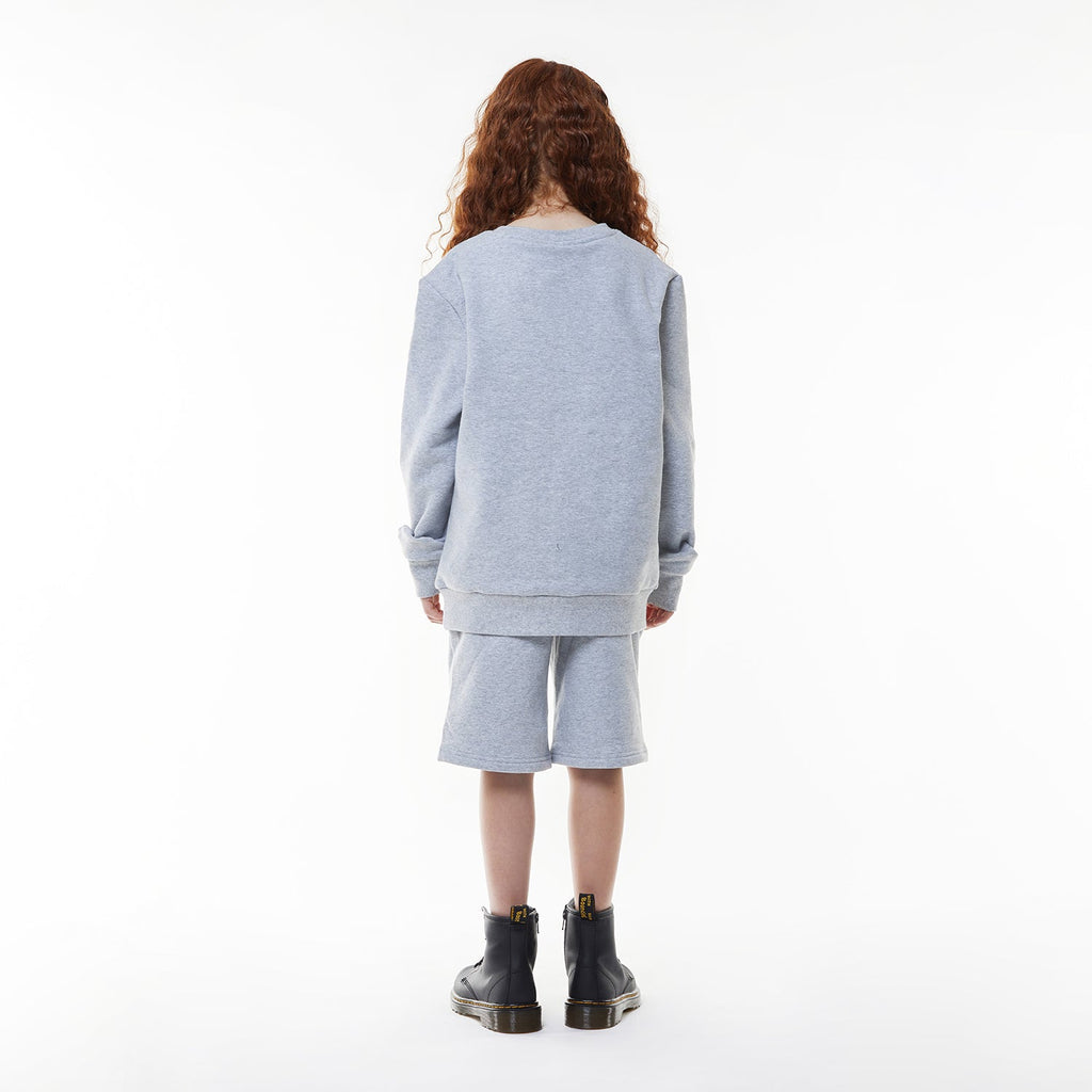 Model wearing BOY London shorts on white background
