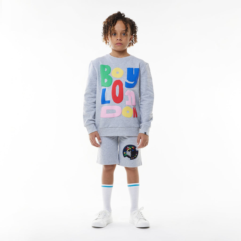 Model wearing BOY London shorts on white background
