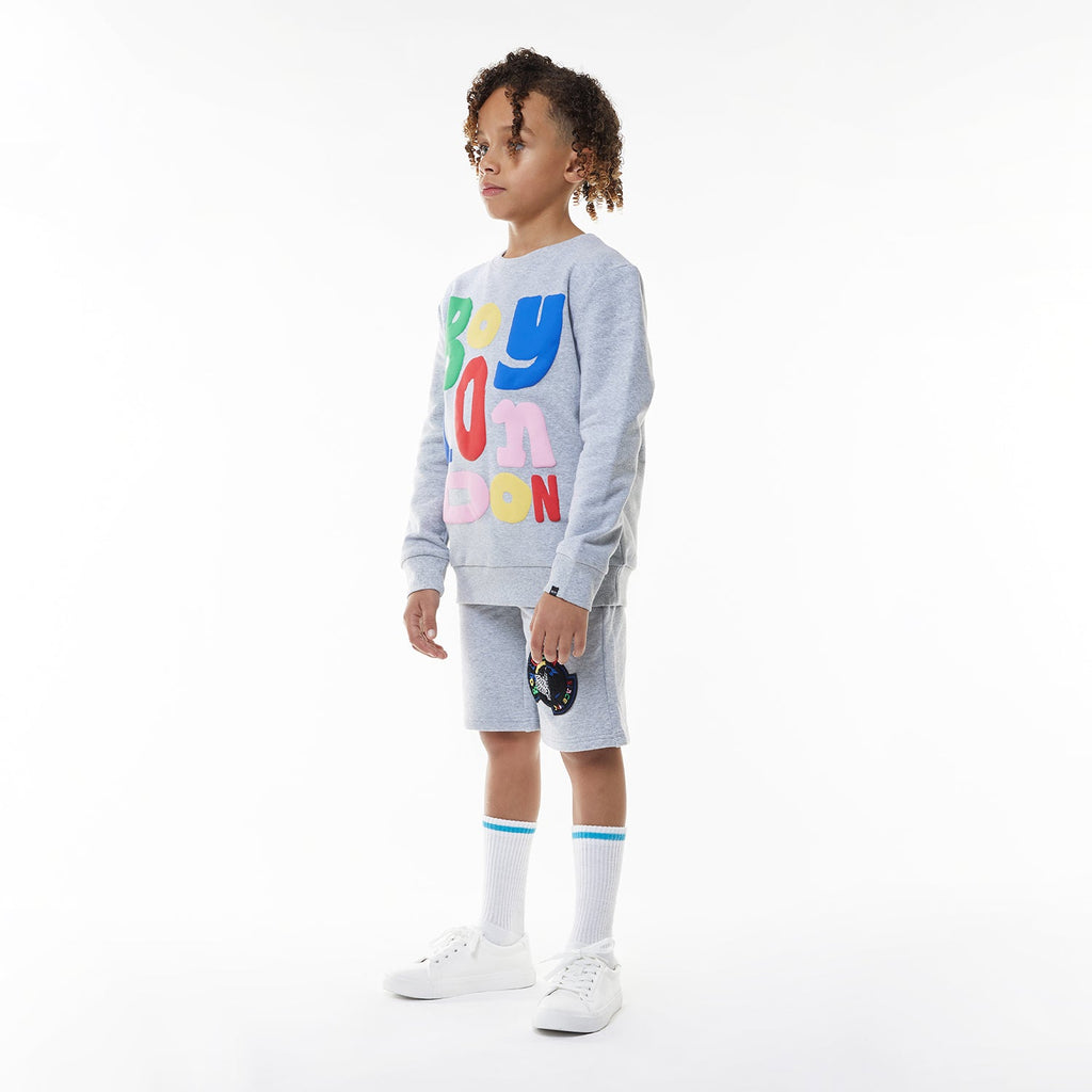 Model wearing BOY London shorts on white background