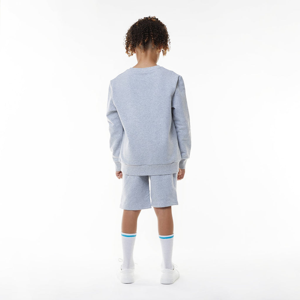Model wearing BOY London shorts on white background