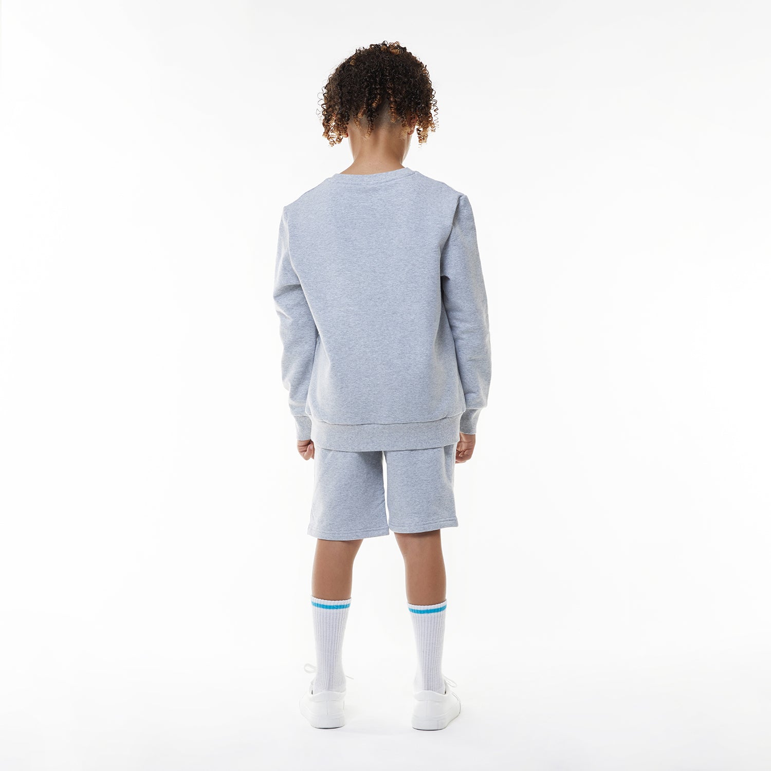 Model wearing BOY London shorts on white background