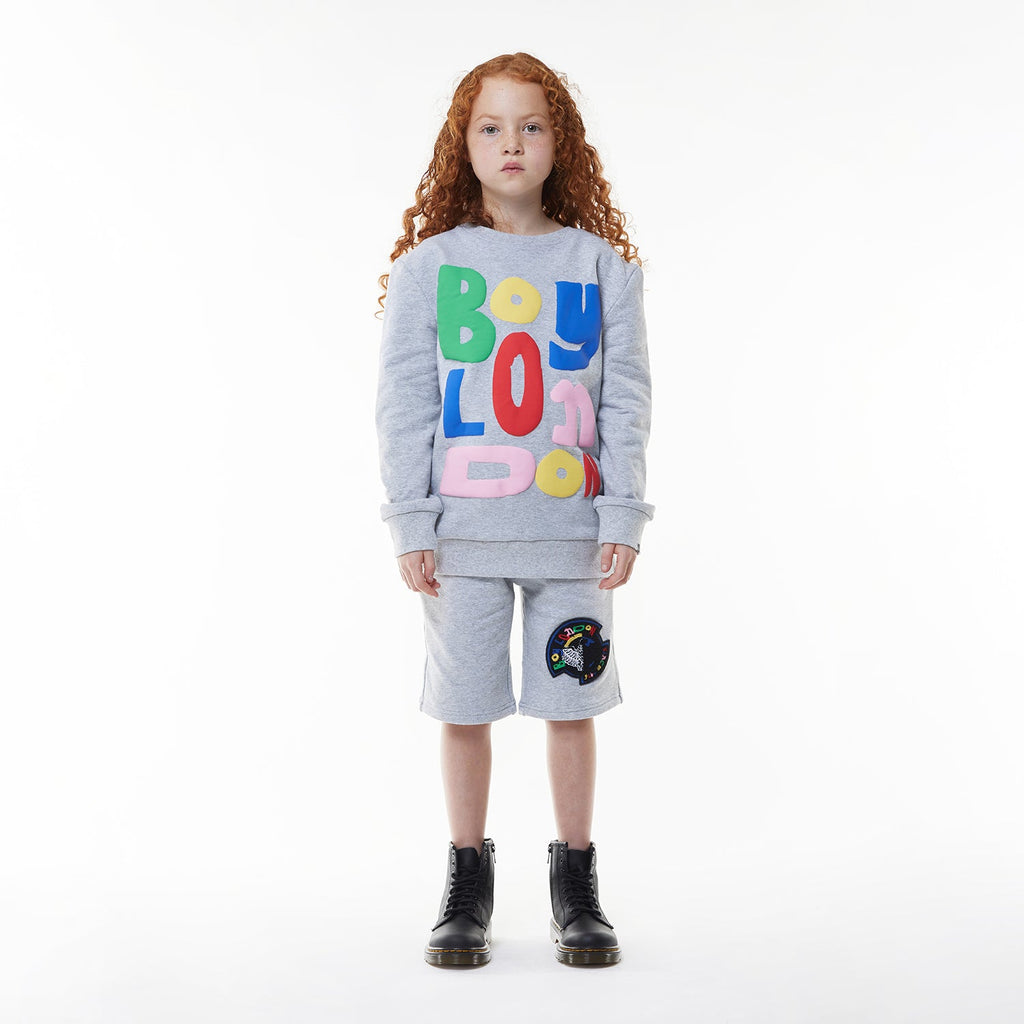 Model wearing BOY London shorts on white background