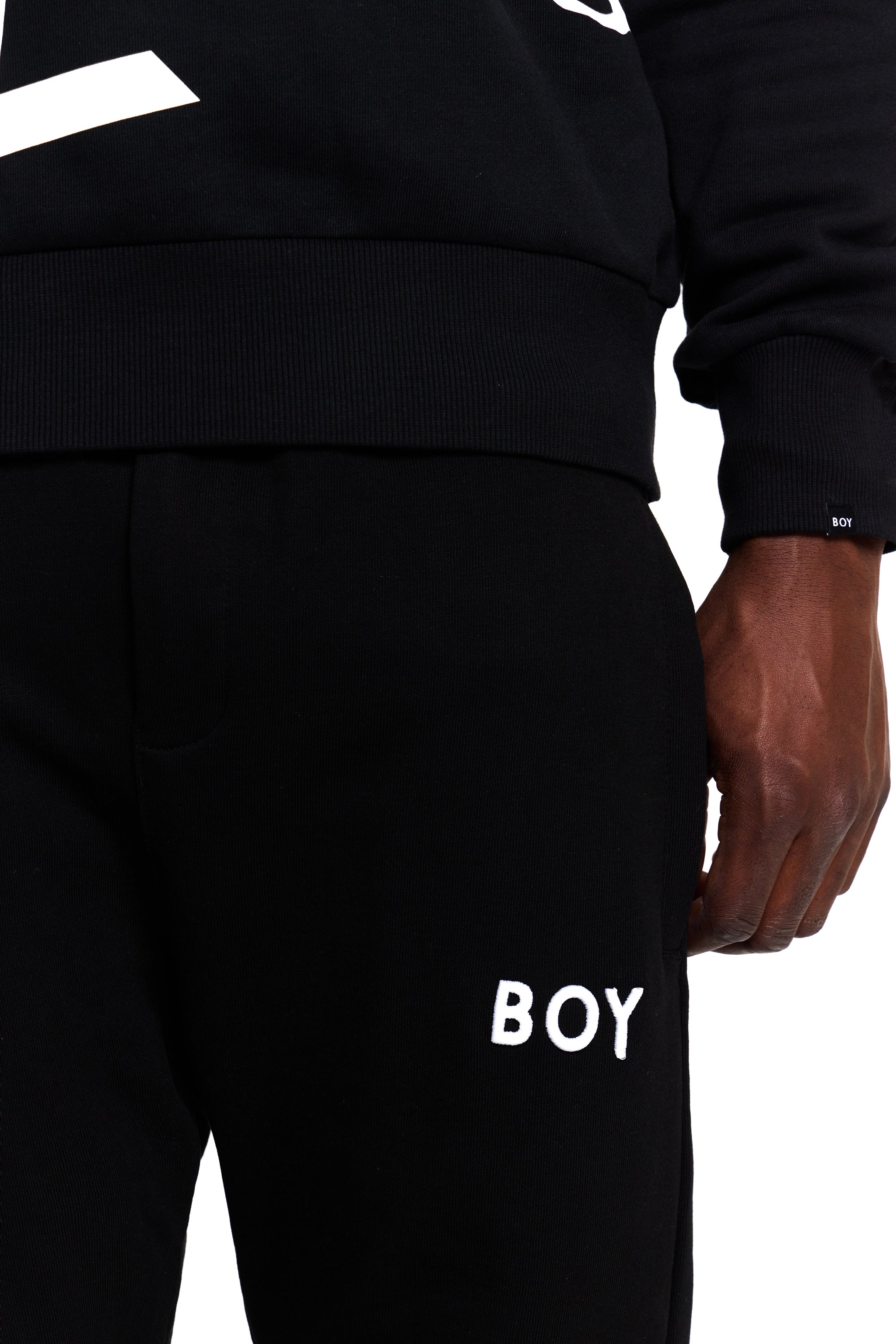 Black sweatpants with 'BOY' London branding on a white background
