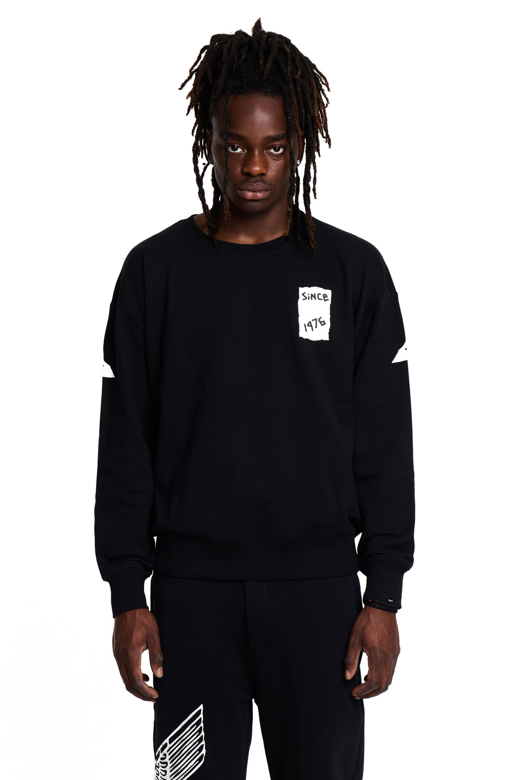 Model wearing a black BOY London sweatshirt with a small white logo on a white background