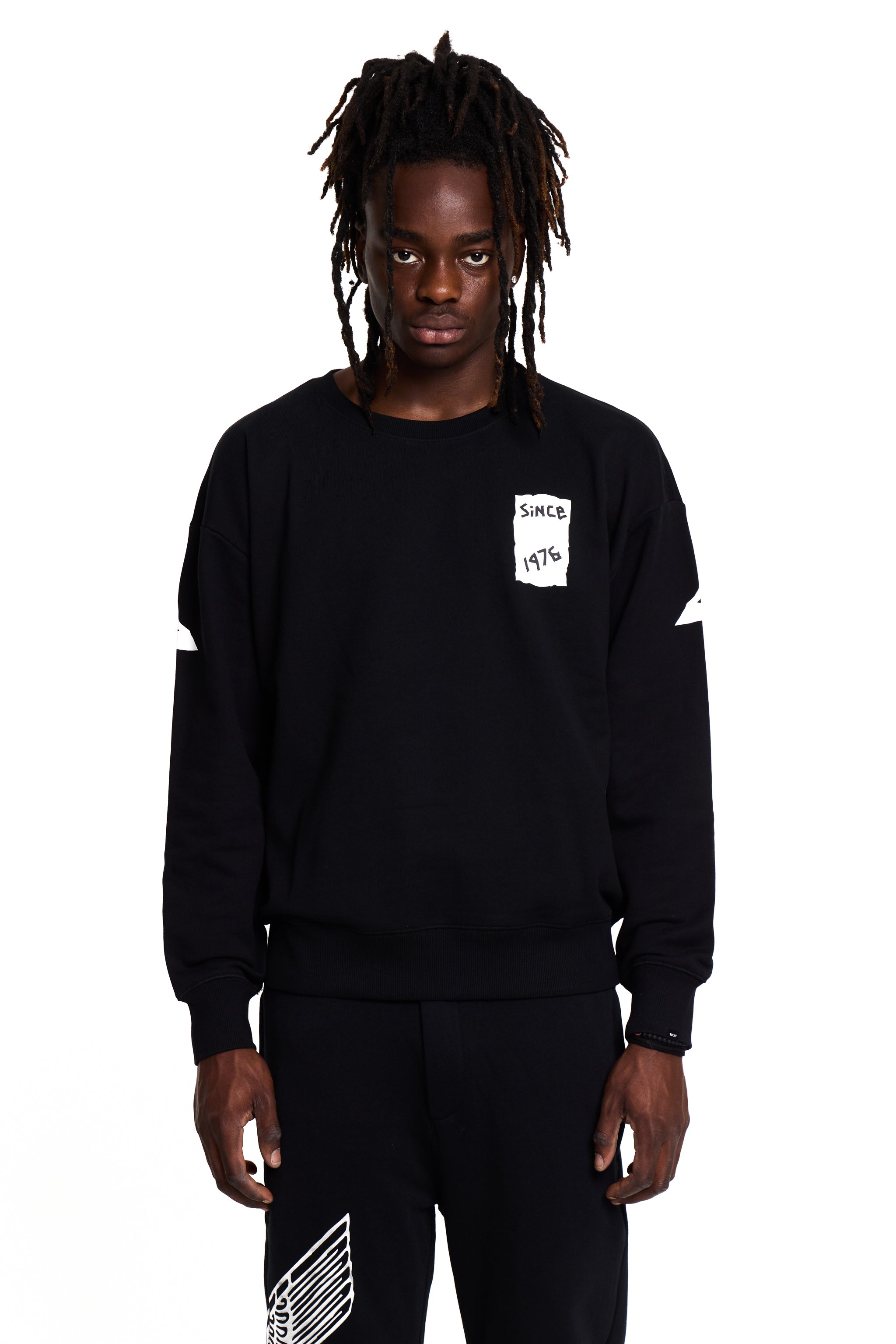Model wearing a black BOY London sweatshirt with a small white logo on a white background