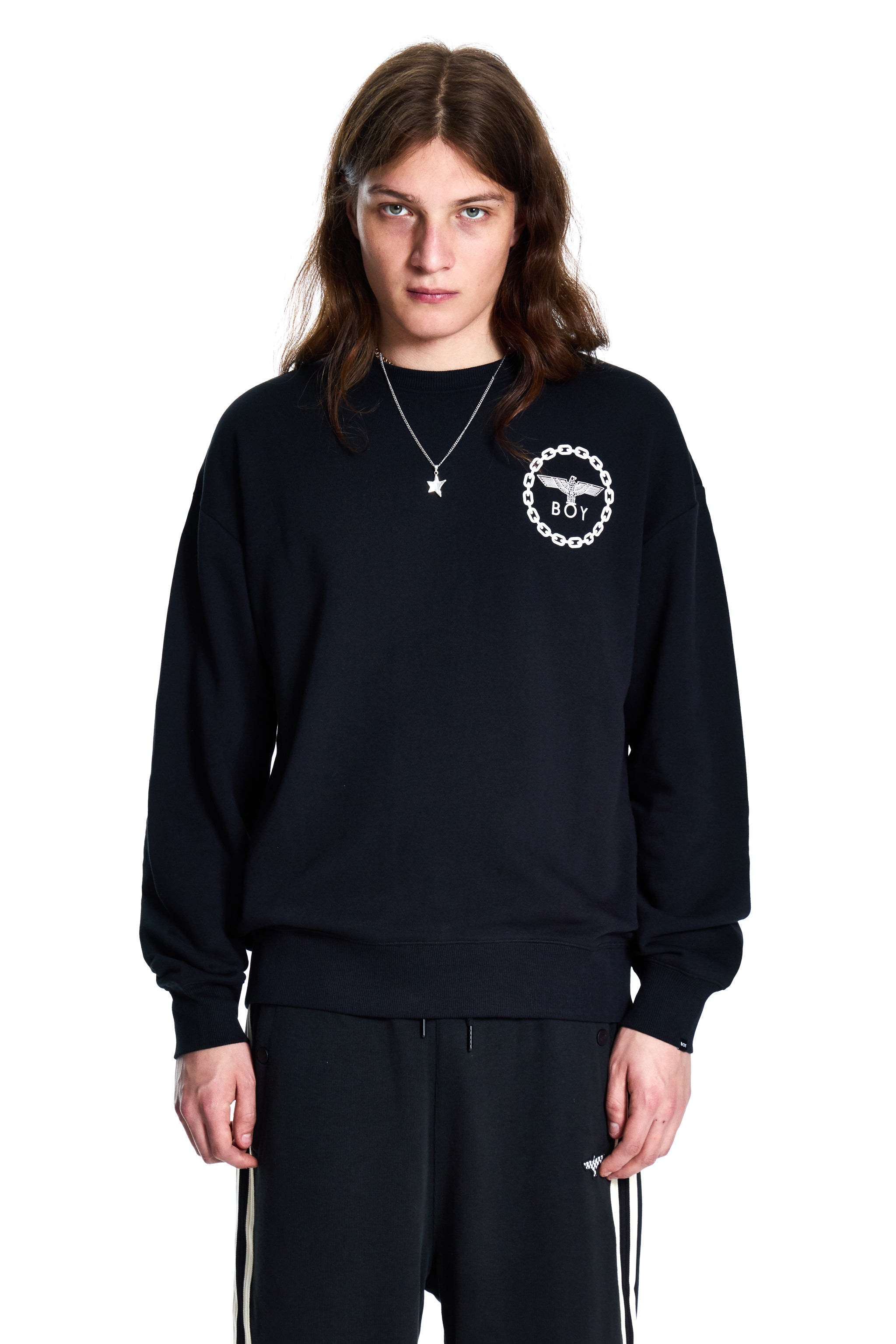 Person wearing a black sweatshirt with a white logo on a white background