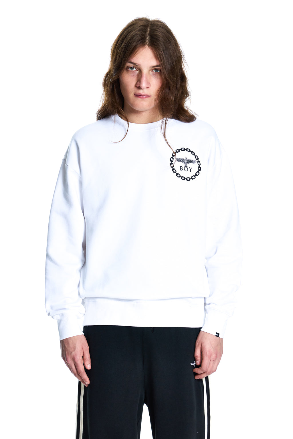 Person wearing a white BOY London sweatshirt with a logo on a white background