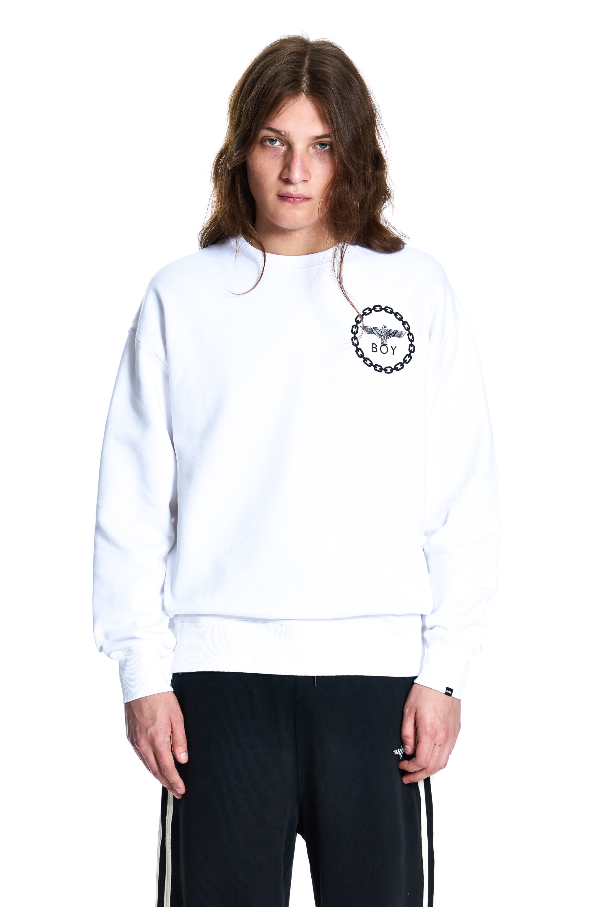 Person wearing a white sweatshirt with a logo on a white background