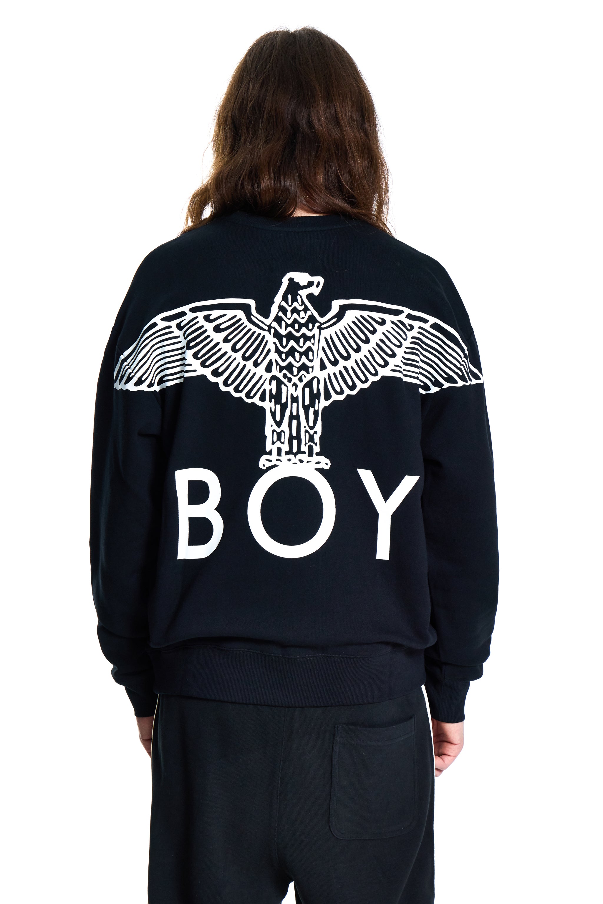 Person wearing a black Boy London sweatshirt with an eagle design and 'BOY' text on the back, on a white background.