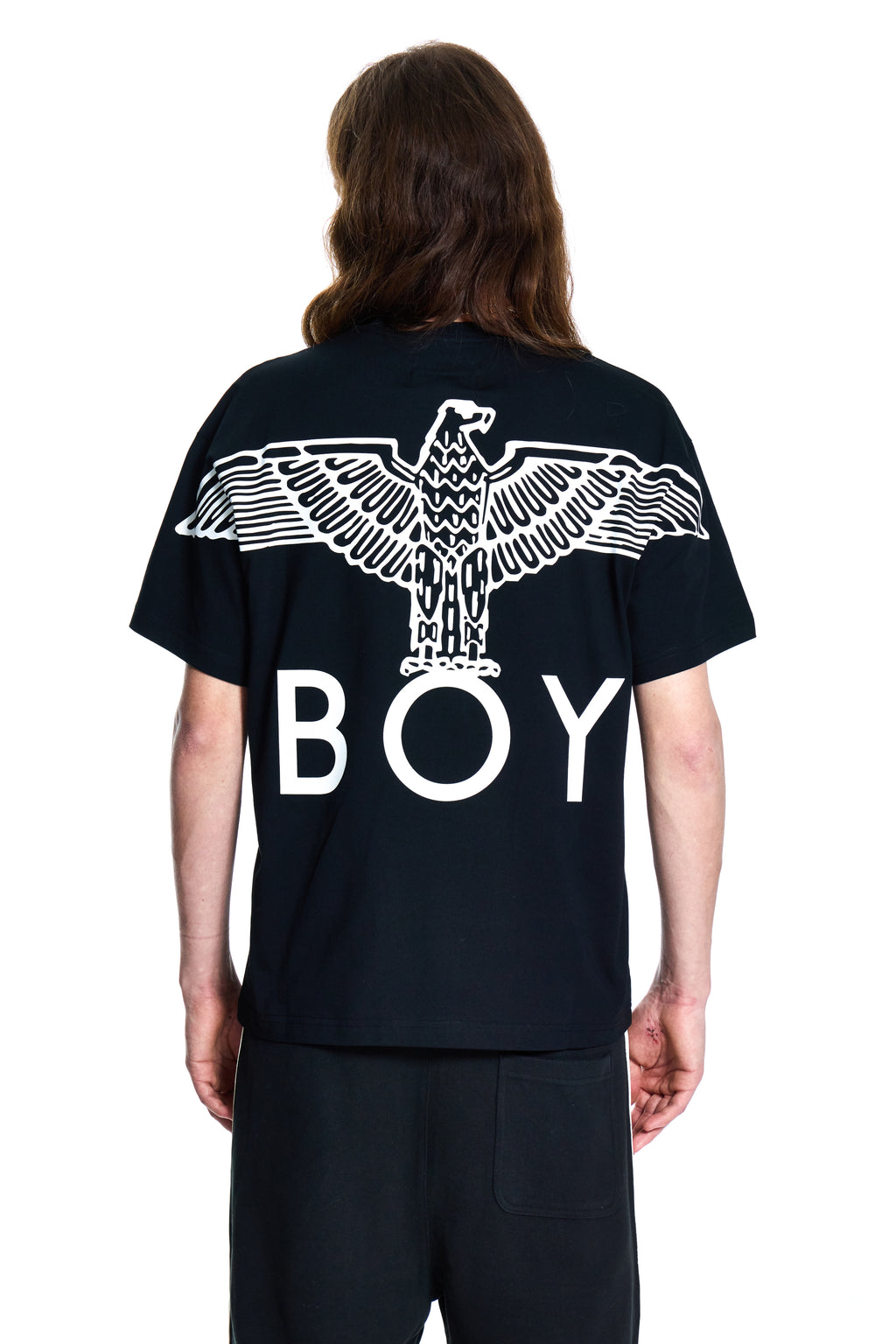 Person wearing a black t-shirt with an eagle design and 'BOY' text on the back.