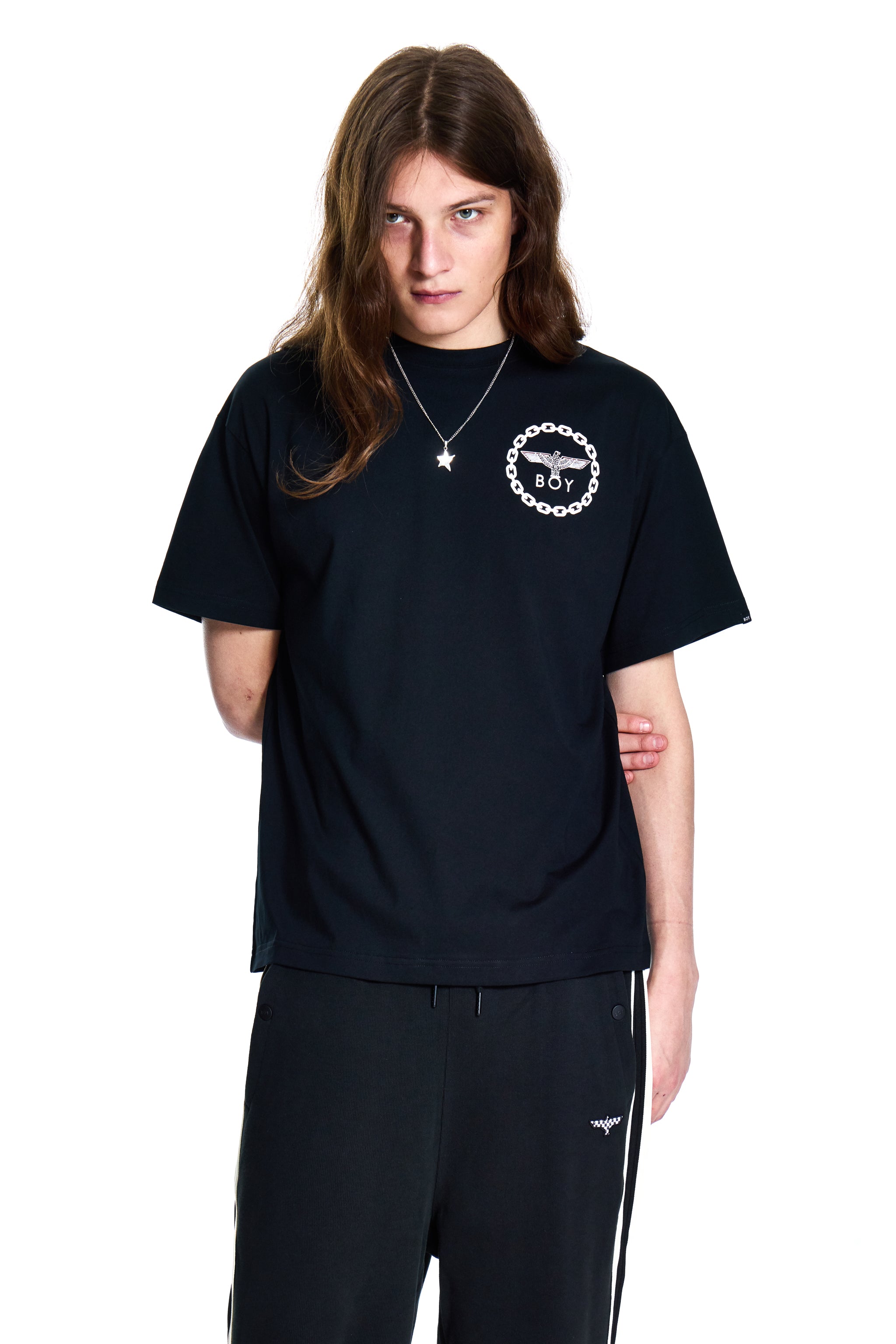 Person wearing a black t-shirt with a logo on a white background