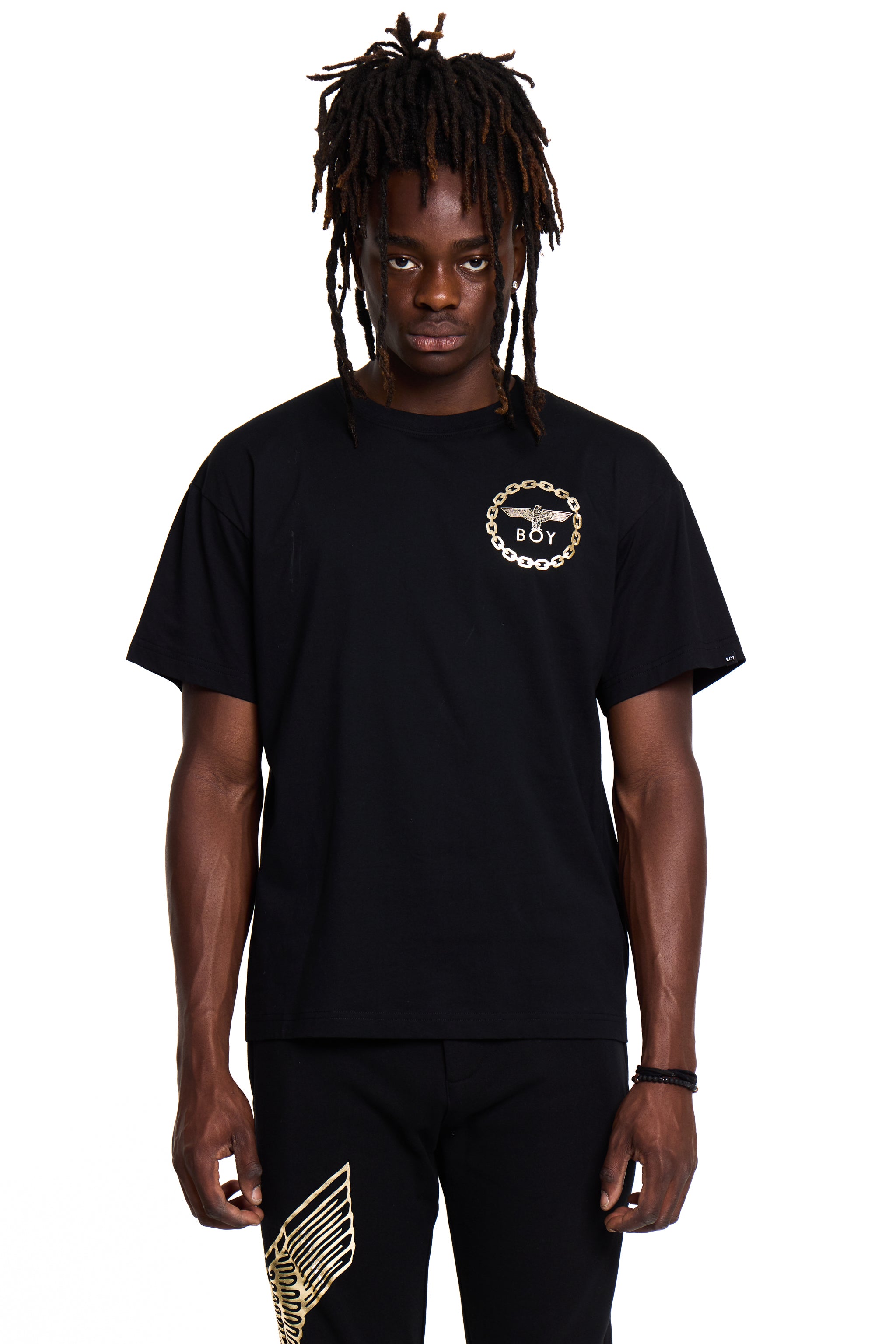 Person wearing a black BOY London t-shirt with a logo on a white background