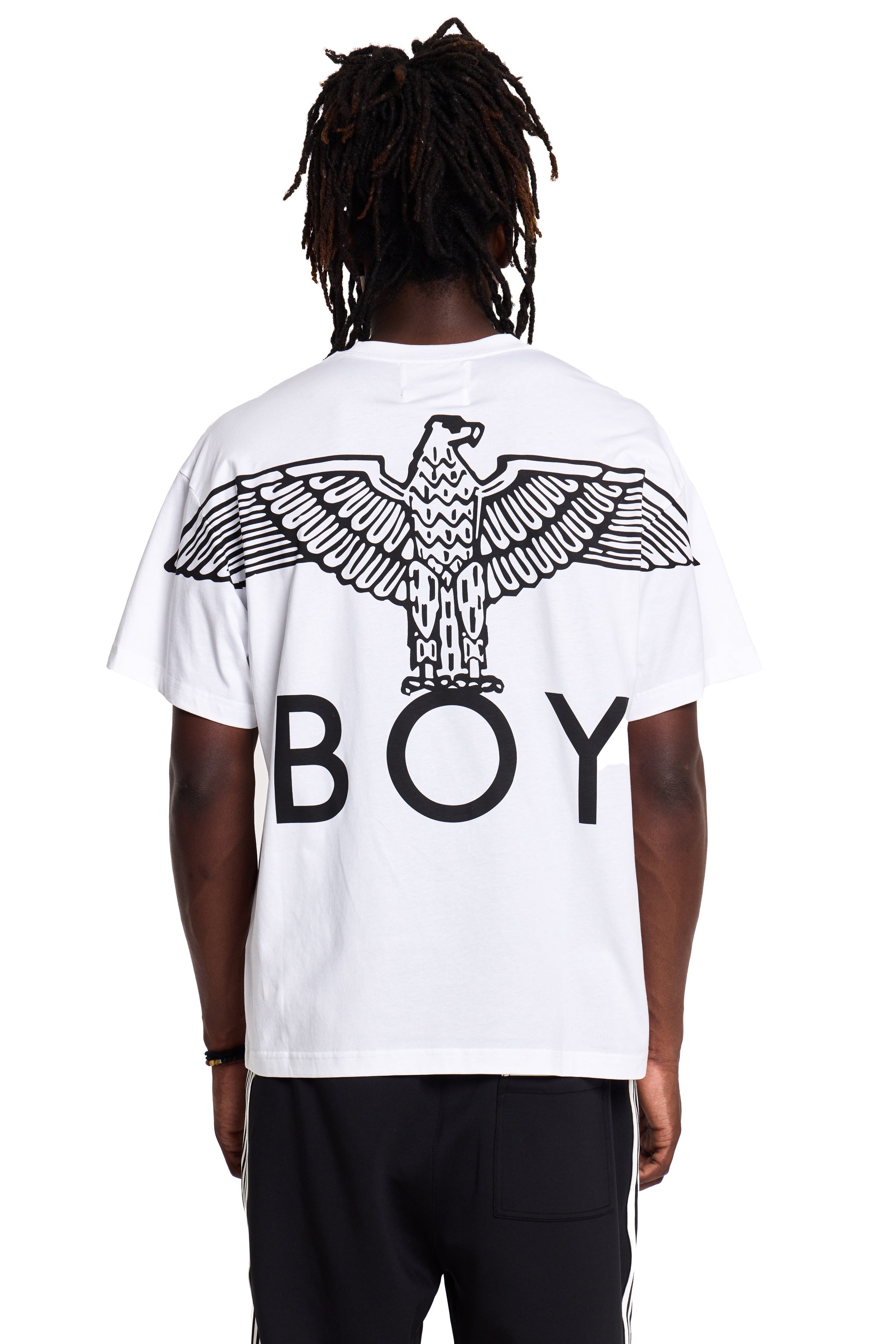 Model wearing Person wearing a white t-shirt with an eagle design and 'BOY' London text on the back.