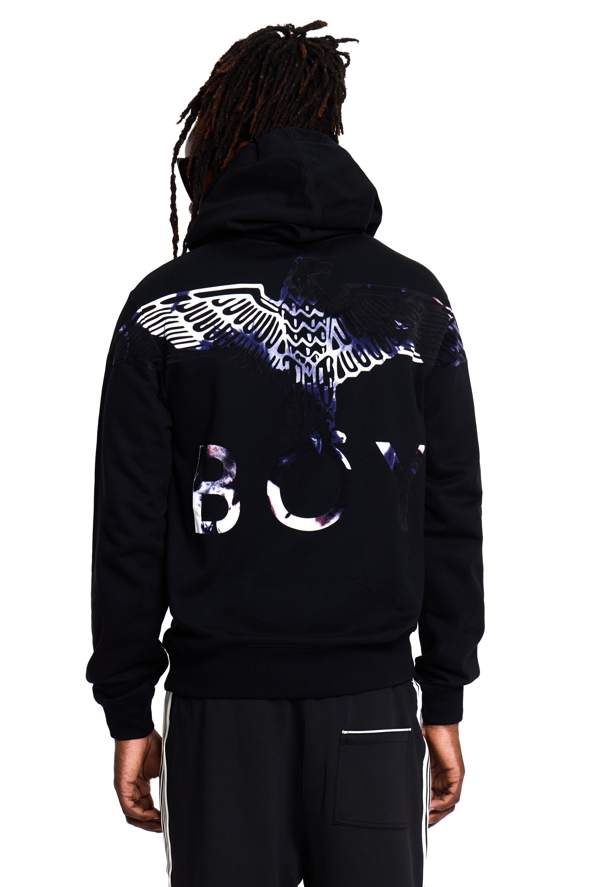 Model wearing a black BOY London hoodie with a logo on the back against a white background