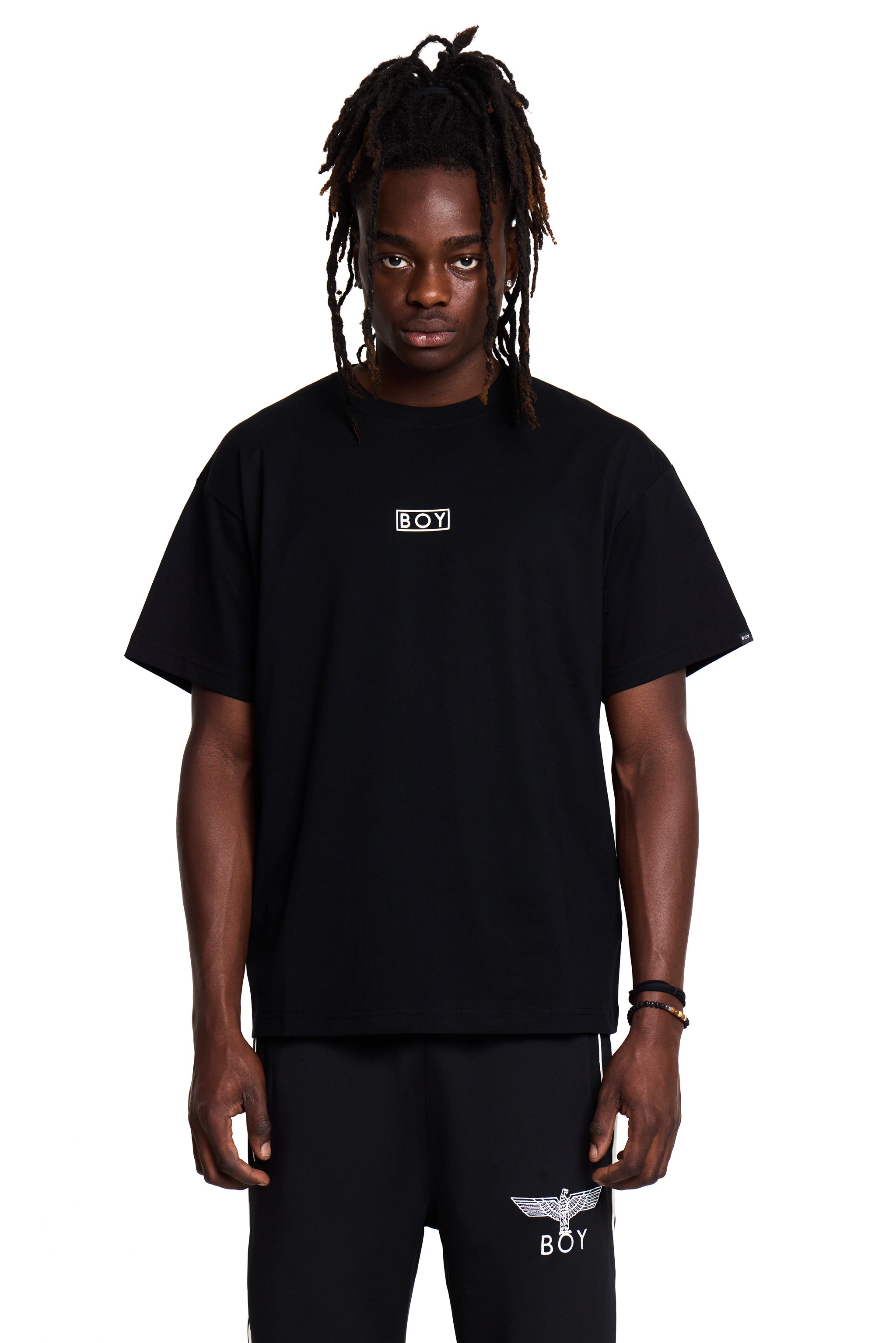 Model wearing a black BOY London t-shirt with a logo on a white background