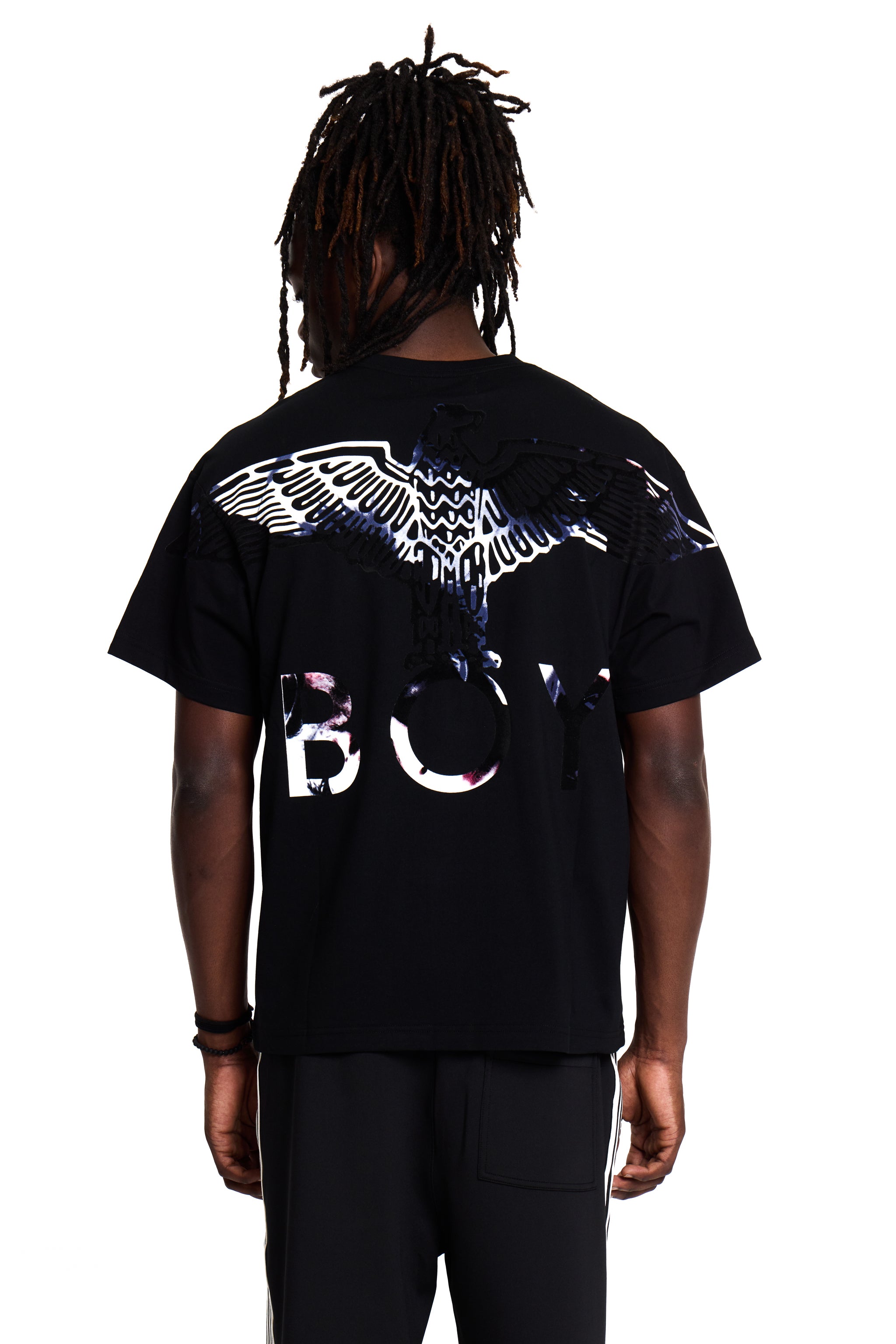 Model wearing a black BOY London t-shirt with a design on the back against a white background