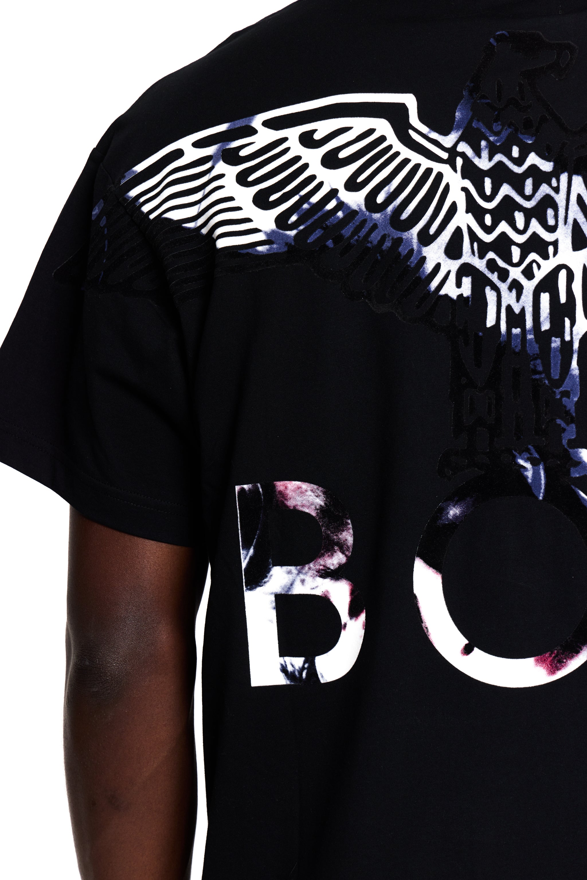 Black BOY London t-shirt with white and multicolor designs on a person wearing it.