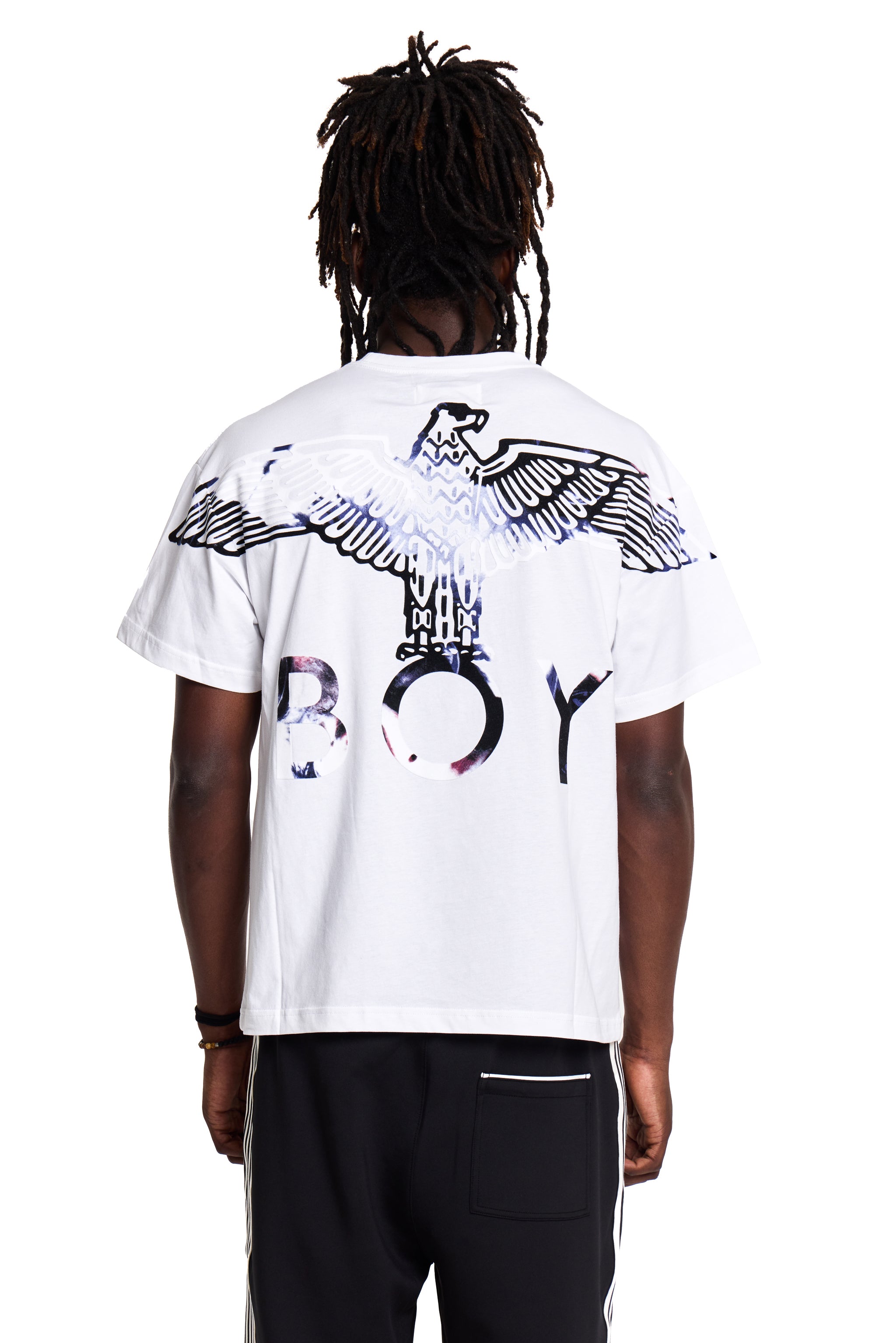 Model wearing a white t-shirt with a graphic design and 'BOY' London text on the back, standing against a white background.