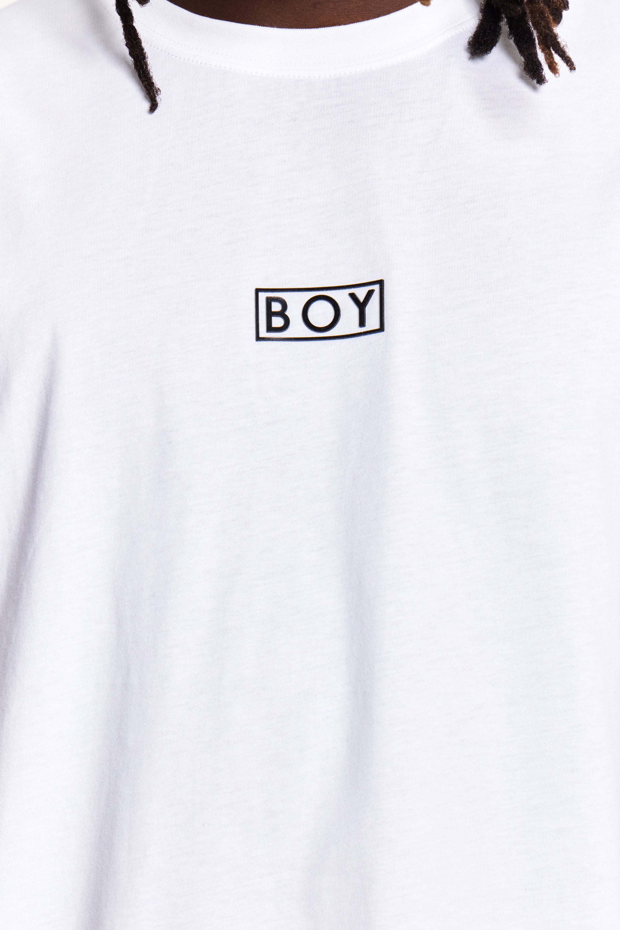 Model wearing white t-shirt with 'BOY' London logo on a white background