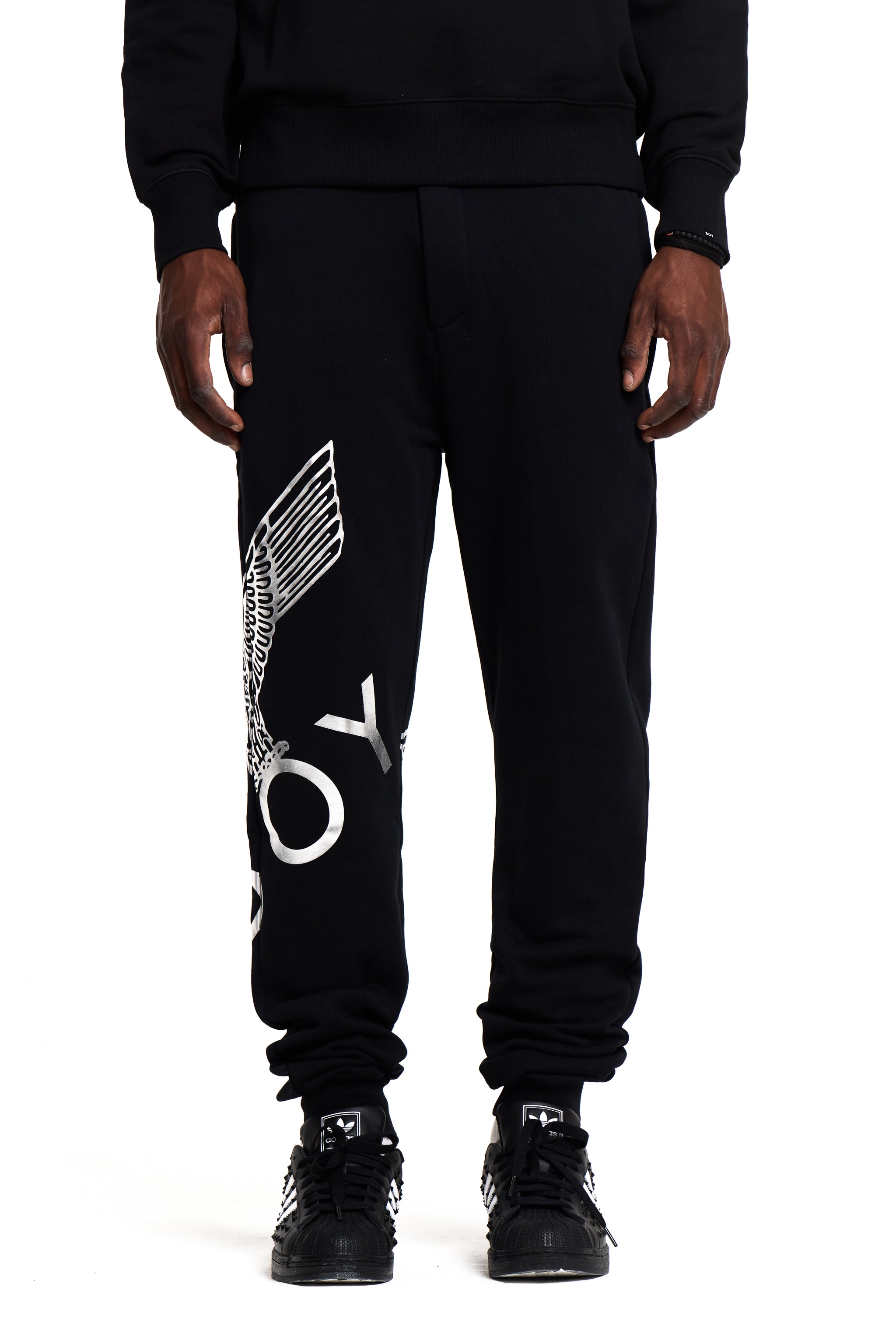 Black BOY London jogger pants with white text and graphics on a white background