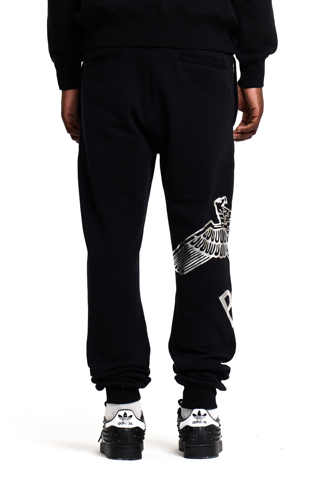 Model wearing Black BOY London sweatpants with white text and graphics on a white background