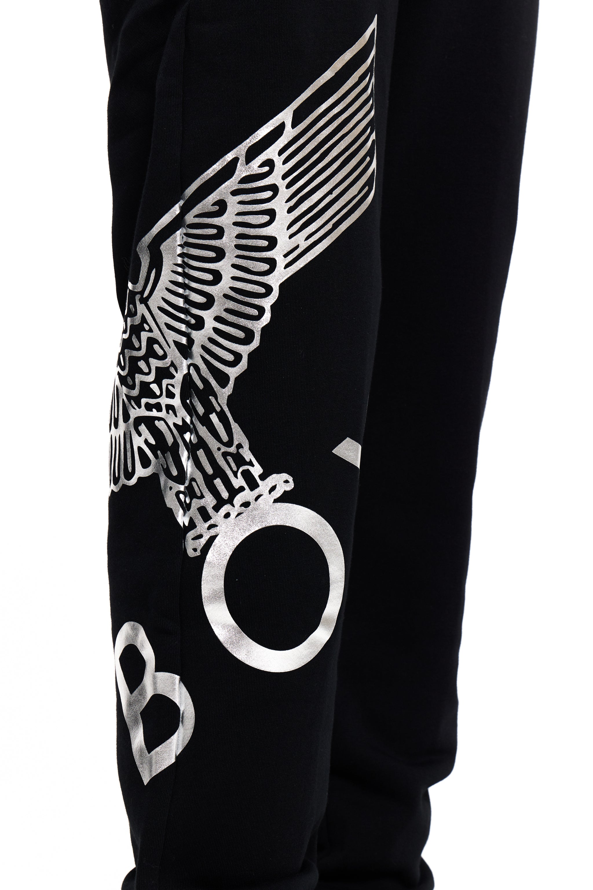 Black pants with a winged logo and 'BOY' London text on a white background
