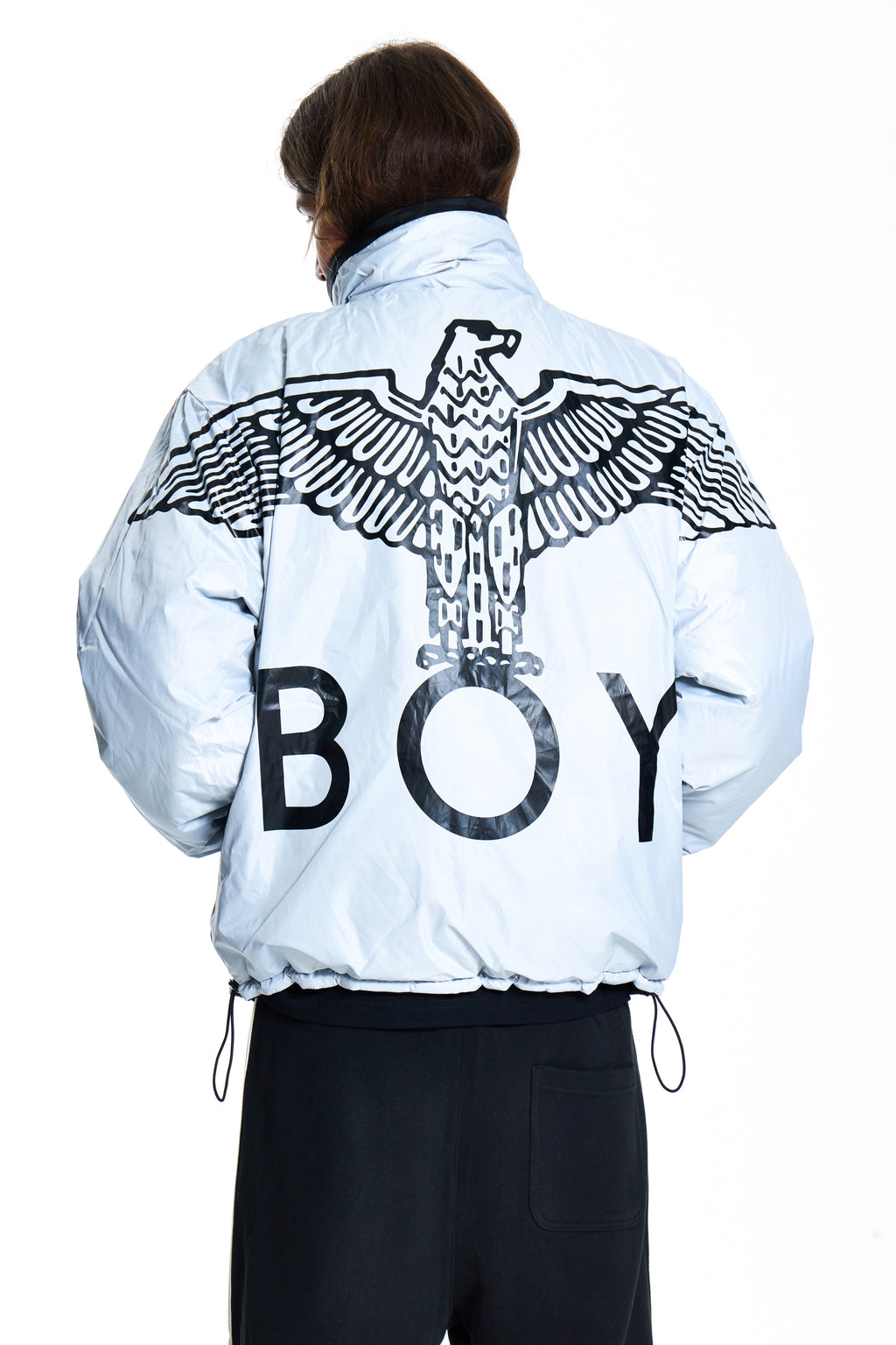 Person wearing a light blue jacket with an eagle design and 'BOY' text on the back, on a white background.