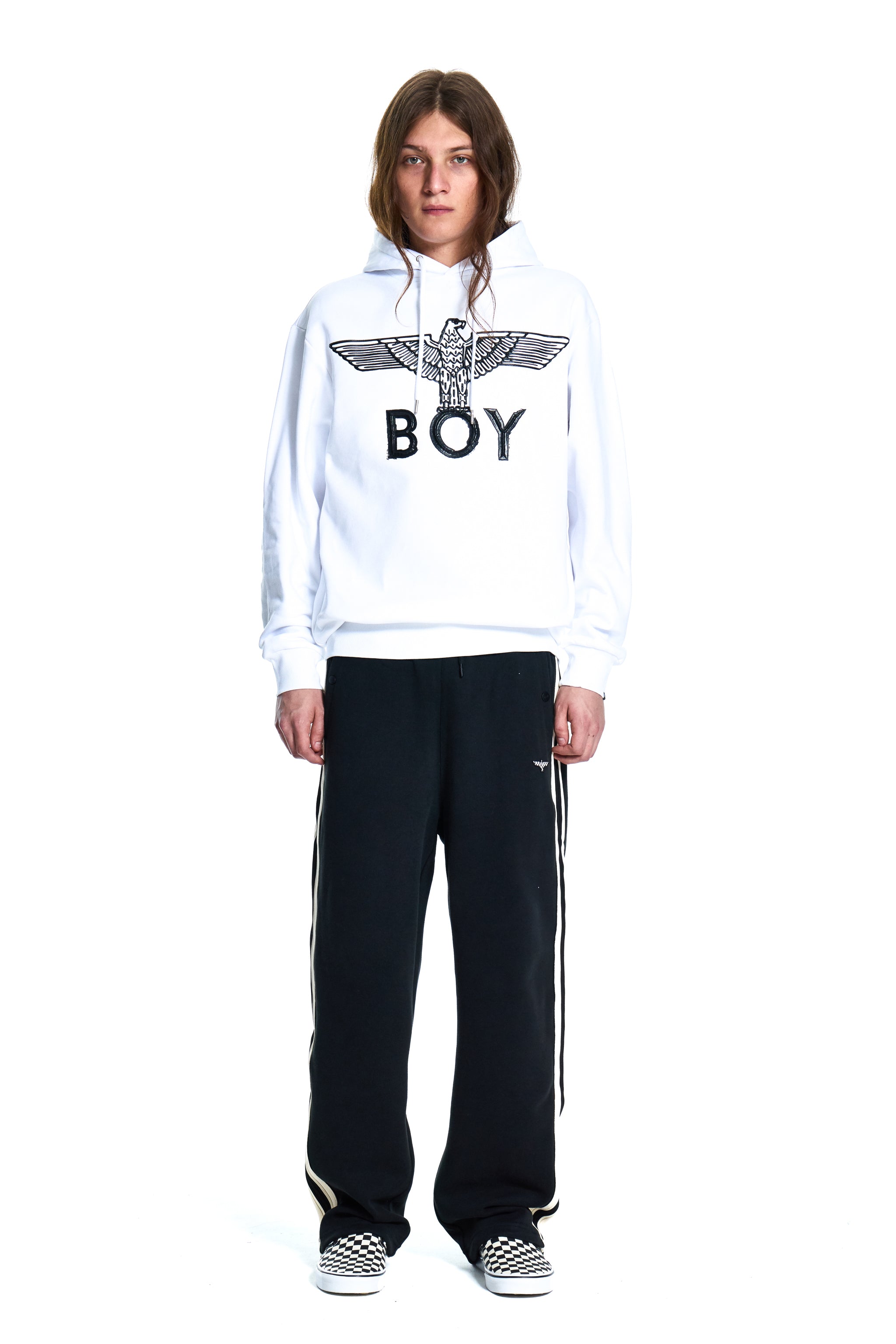 Person wearing a white hoodie with 'BOY' logo and black pants on a white background