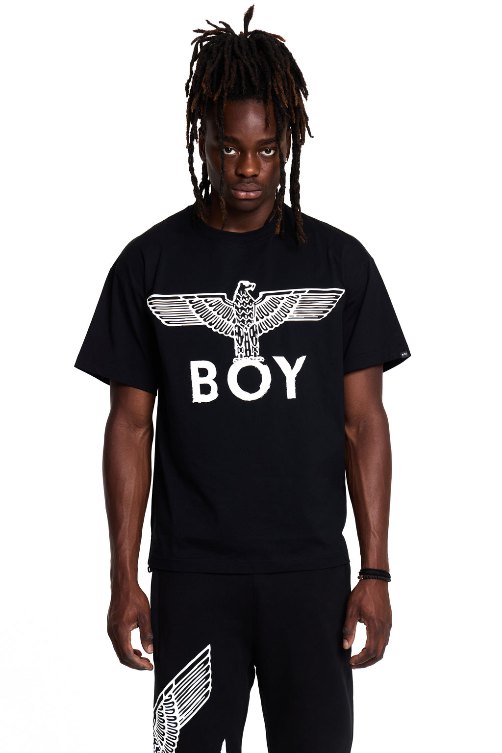 Person wearing a black t-shirt with 'BOY' London logo on a white background