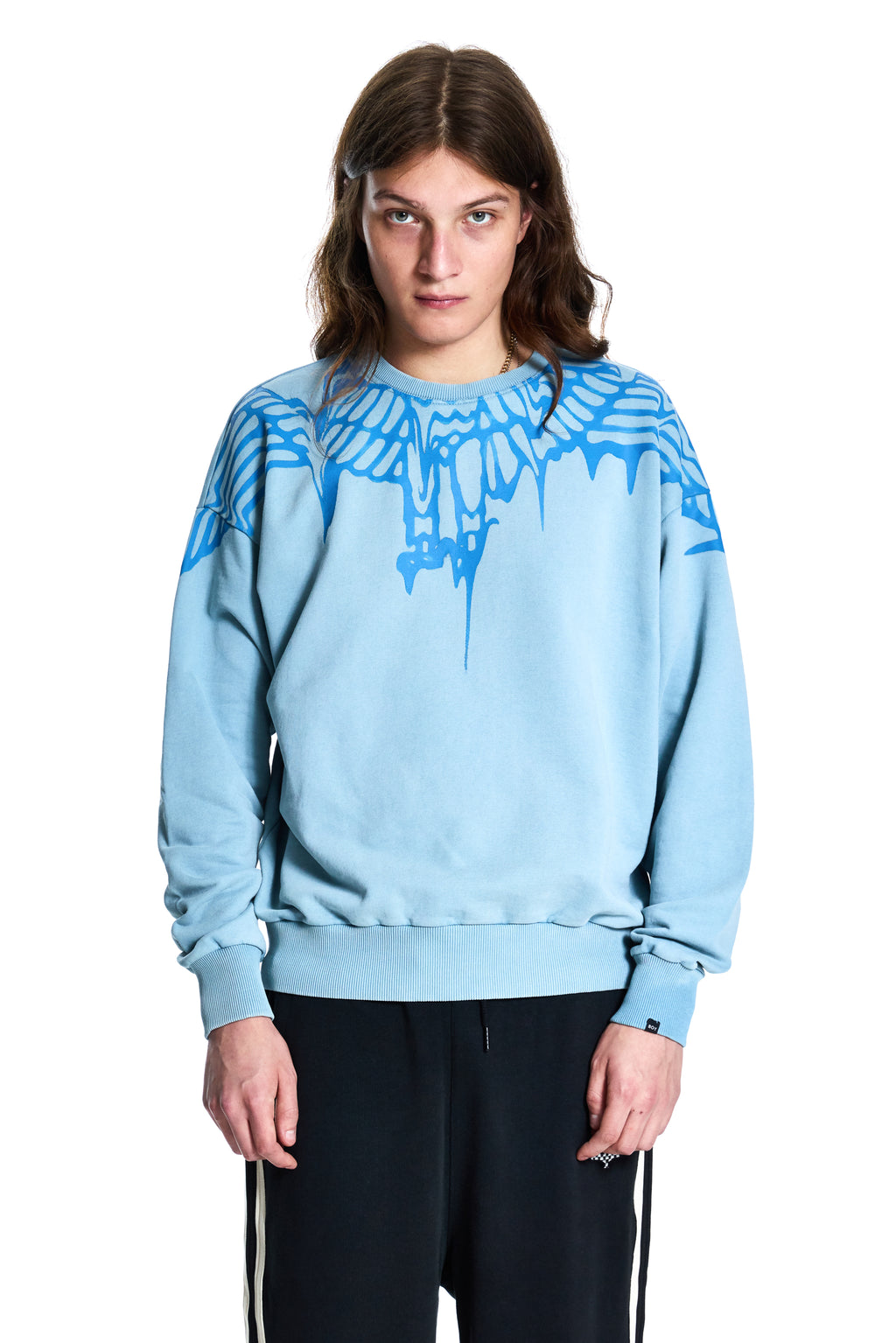 Person wearing a light blue Boy London sweatshirt with a graphic design on a white background