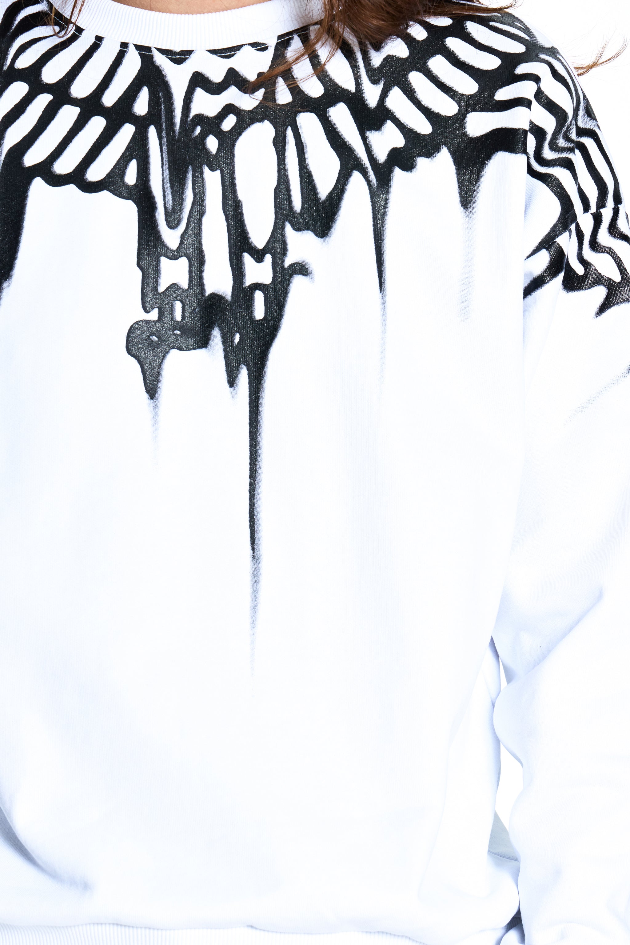 White sweatshirt with black skeleton design on a white background