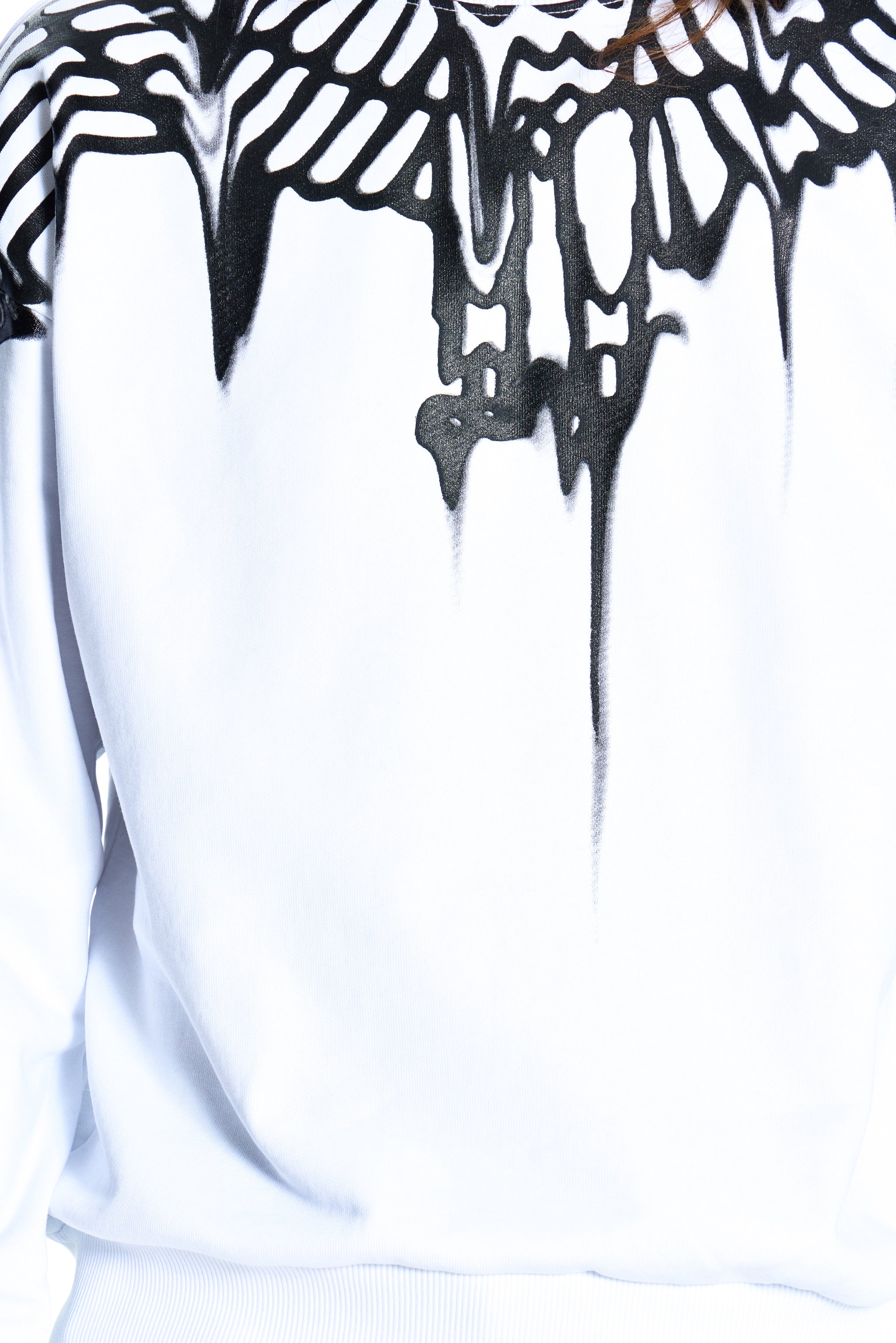 Close-up of a white garment with black abstract pattern