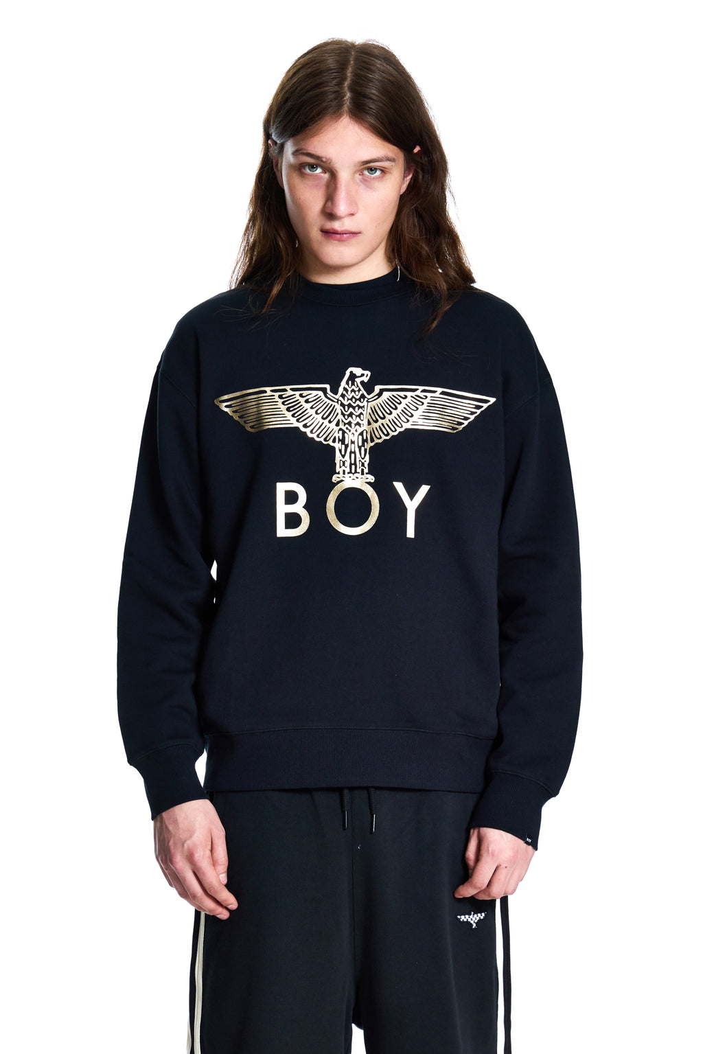 Person wearing a black sweatshirt with 'BOY' and an eagle design on a white background