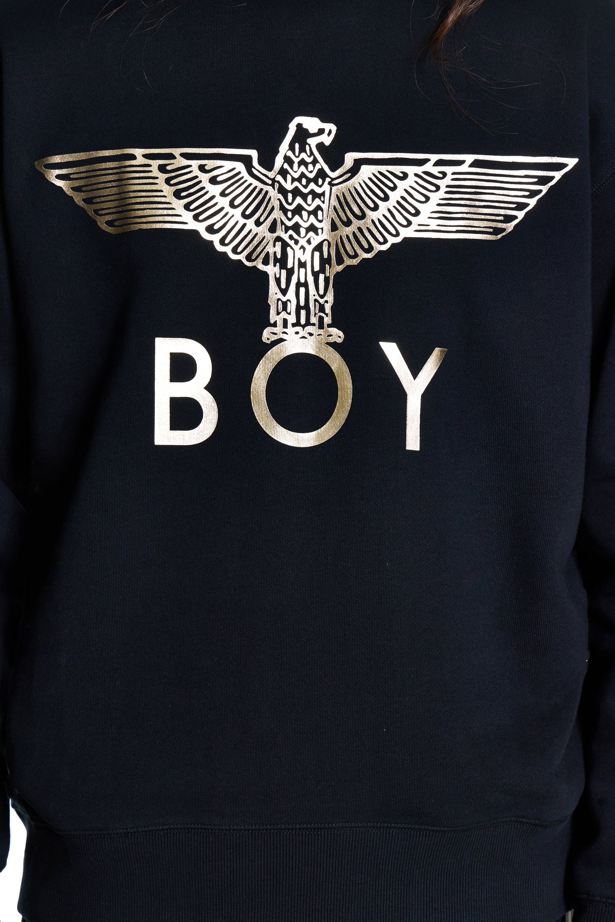Black sweatshirt with gold eagle design and 'BOY' text on a dark background
