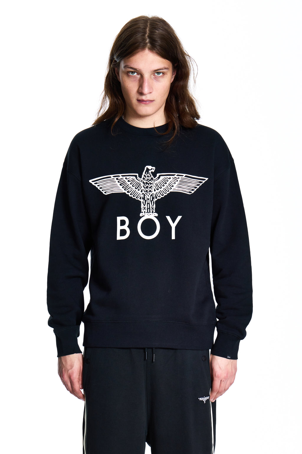 Person wearing a black sweatshirt with 'BOY' and an eagle design on a white background