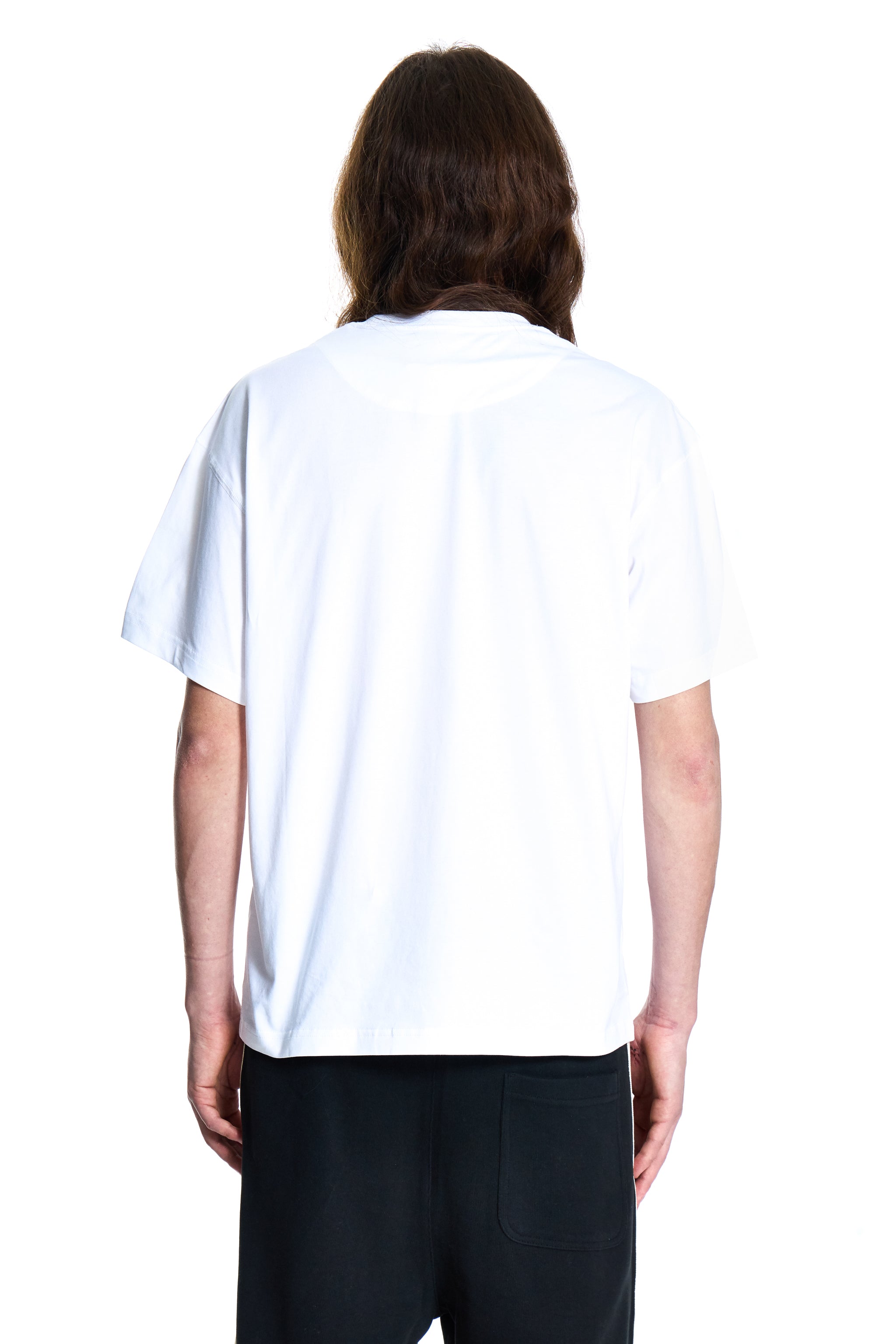 Person wearing a plain white t-shirt on a white background