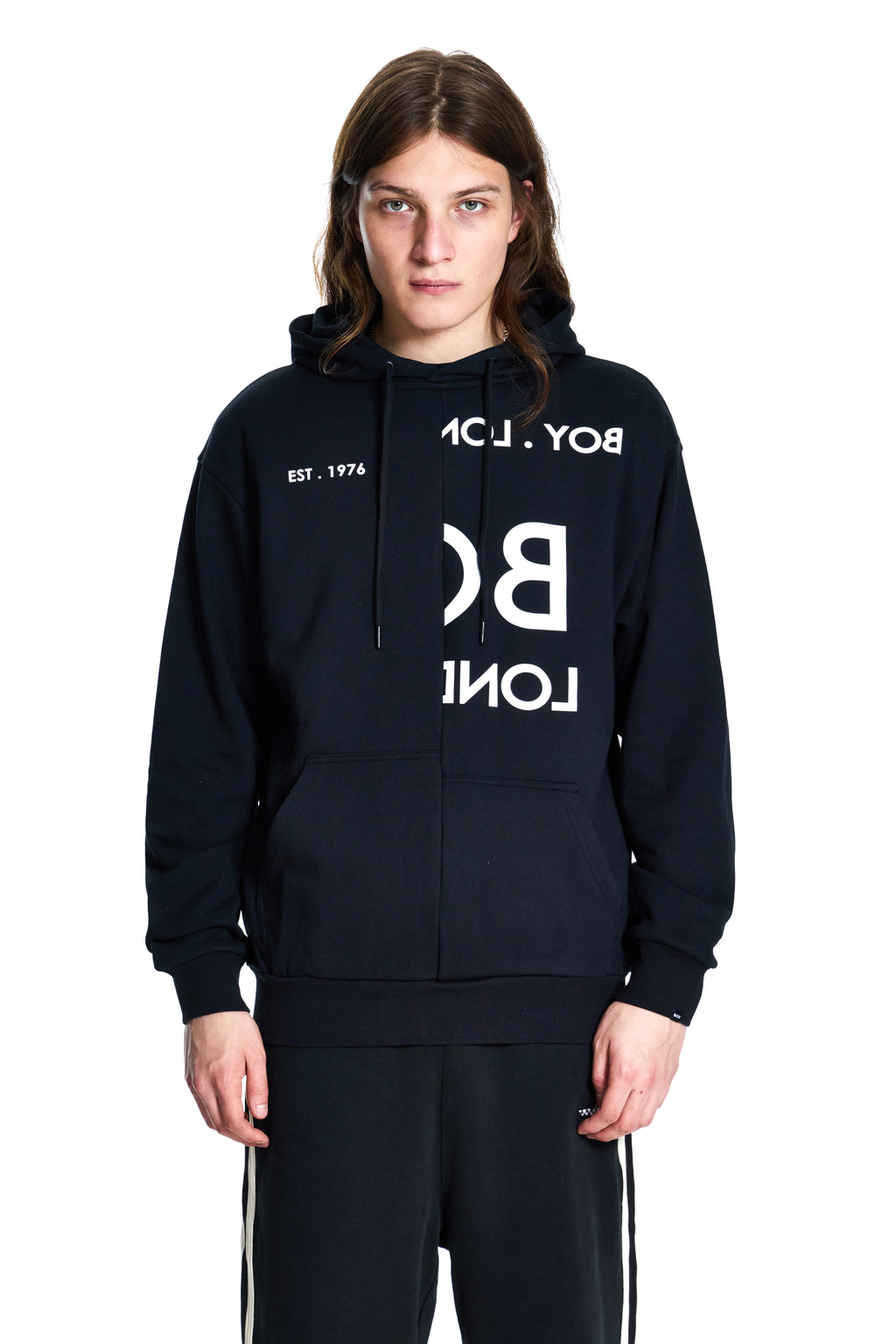 Person wearing a black hoodie with white text on a white background