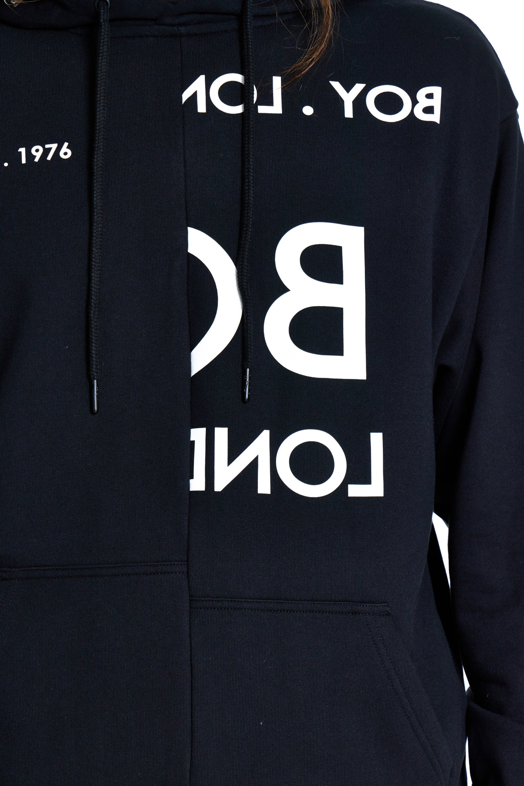 Black hoodie with white branding on a plain background