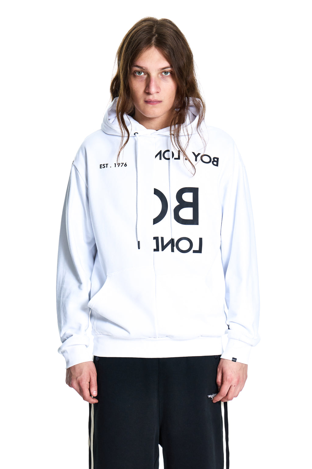 Person wearing a white hoodie with black text on a white background