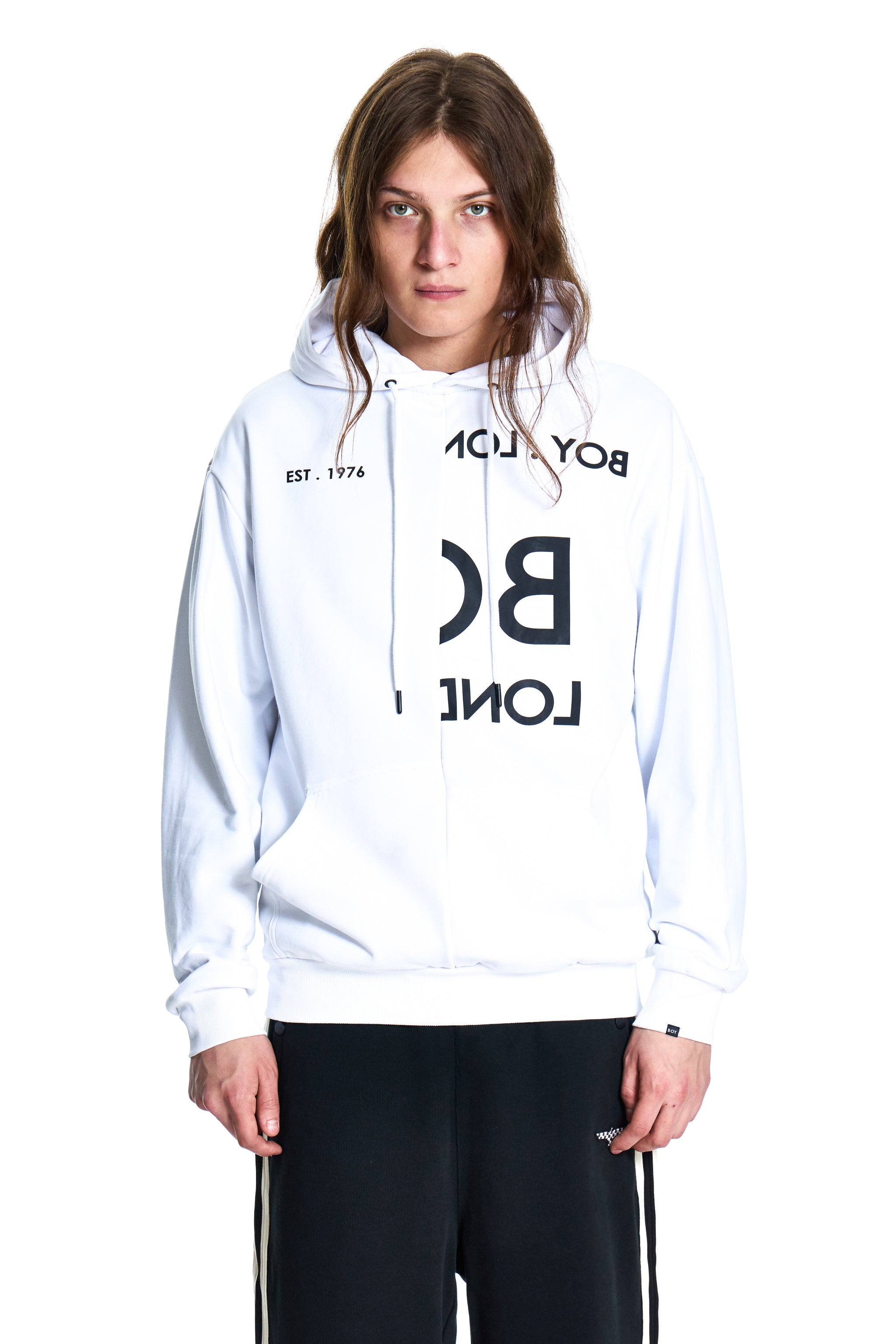Person wearing a white hoodie with black text on a white background