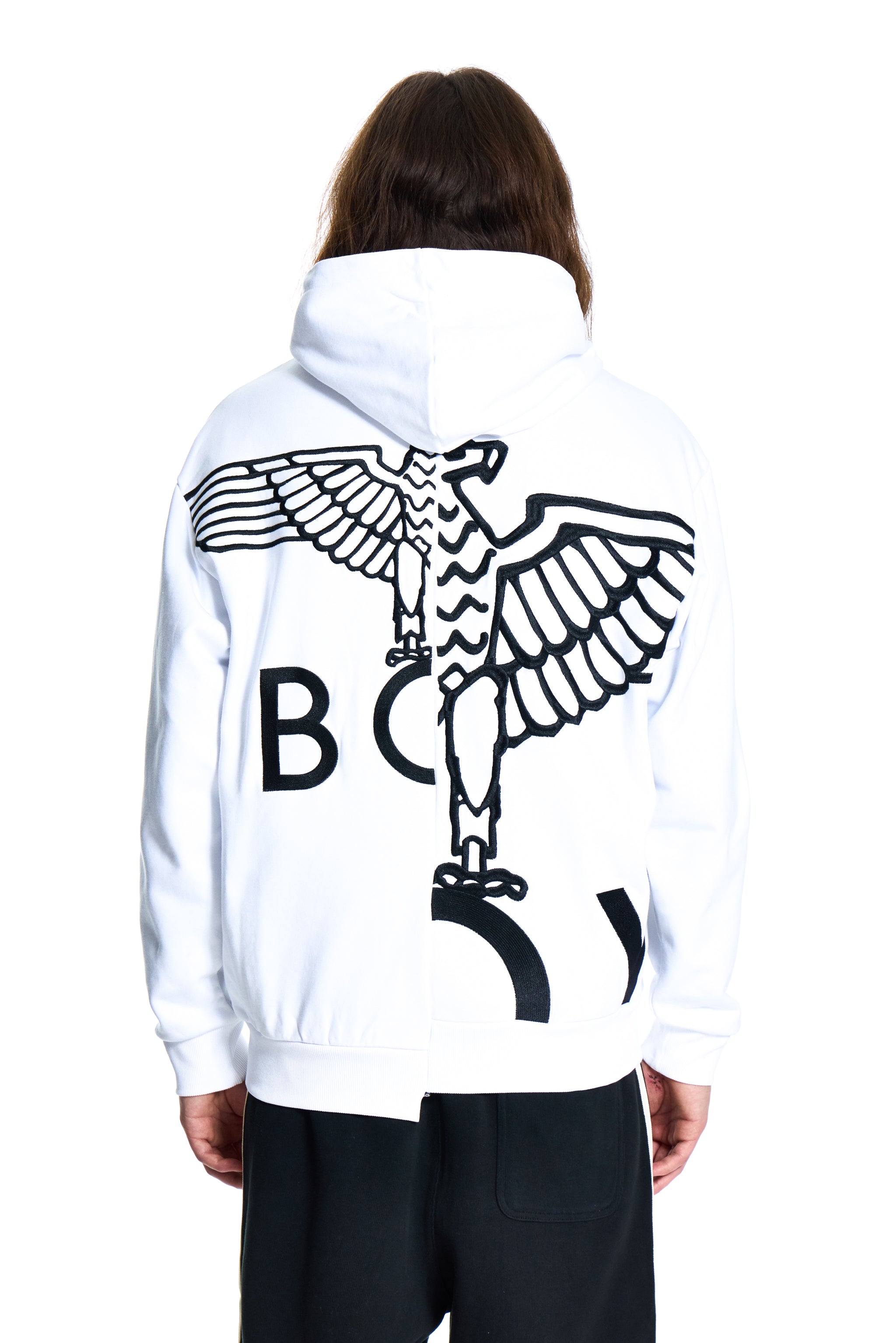 White hoodie with black eagle design on the back, worn by a person on a white background