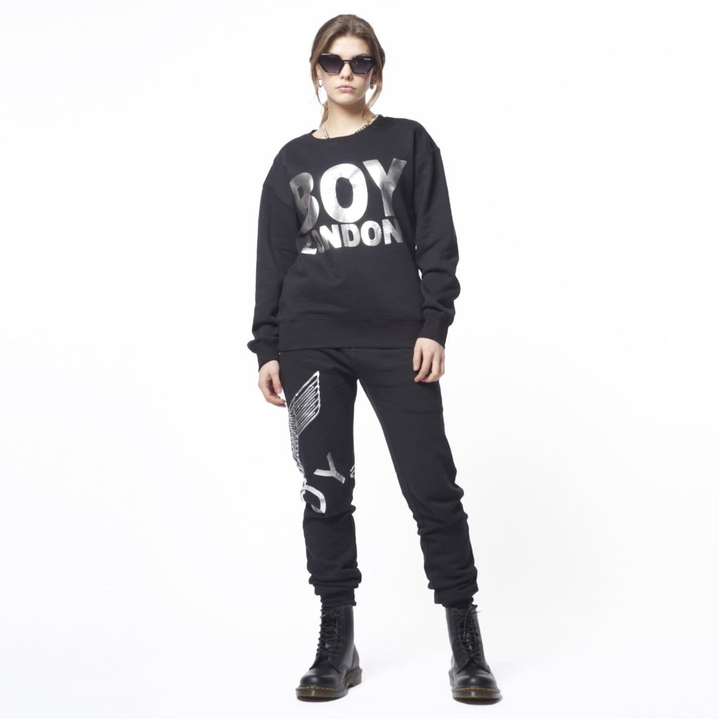 Model wearing Black sweatshirt with 'BOY LONDON' text on a white background