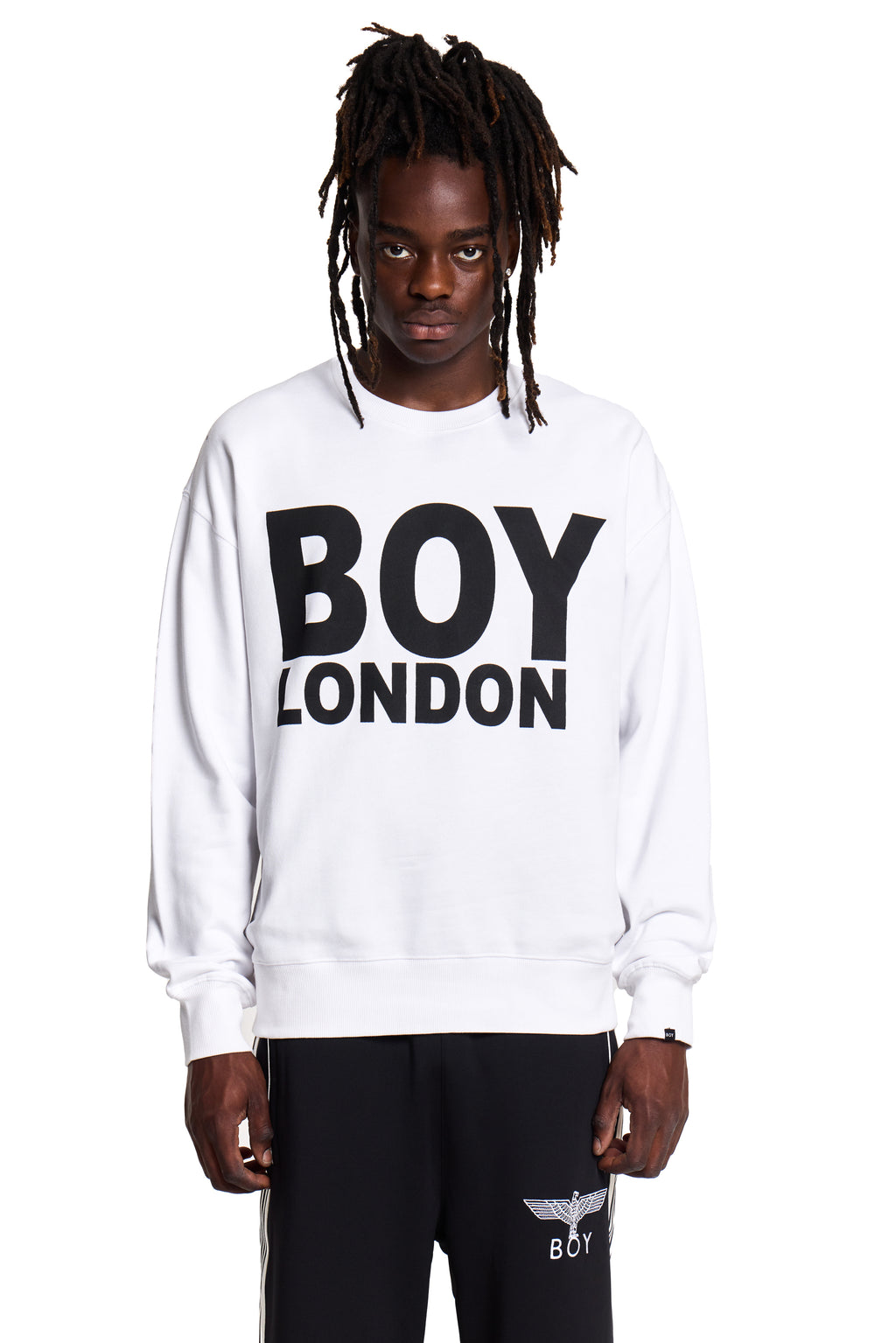 Model wearing a white sweatshirt with 'BOY LONDON' text on a white background