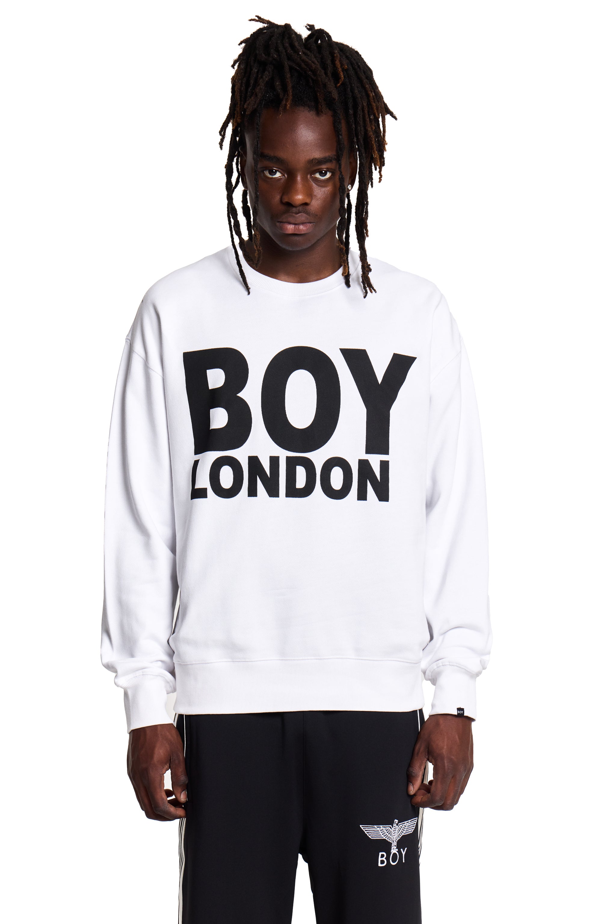Model wearing a white sweatshirt with 'BOY LONDON' text on a white background
