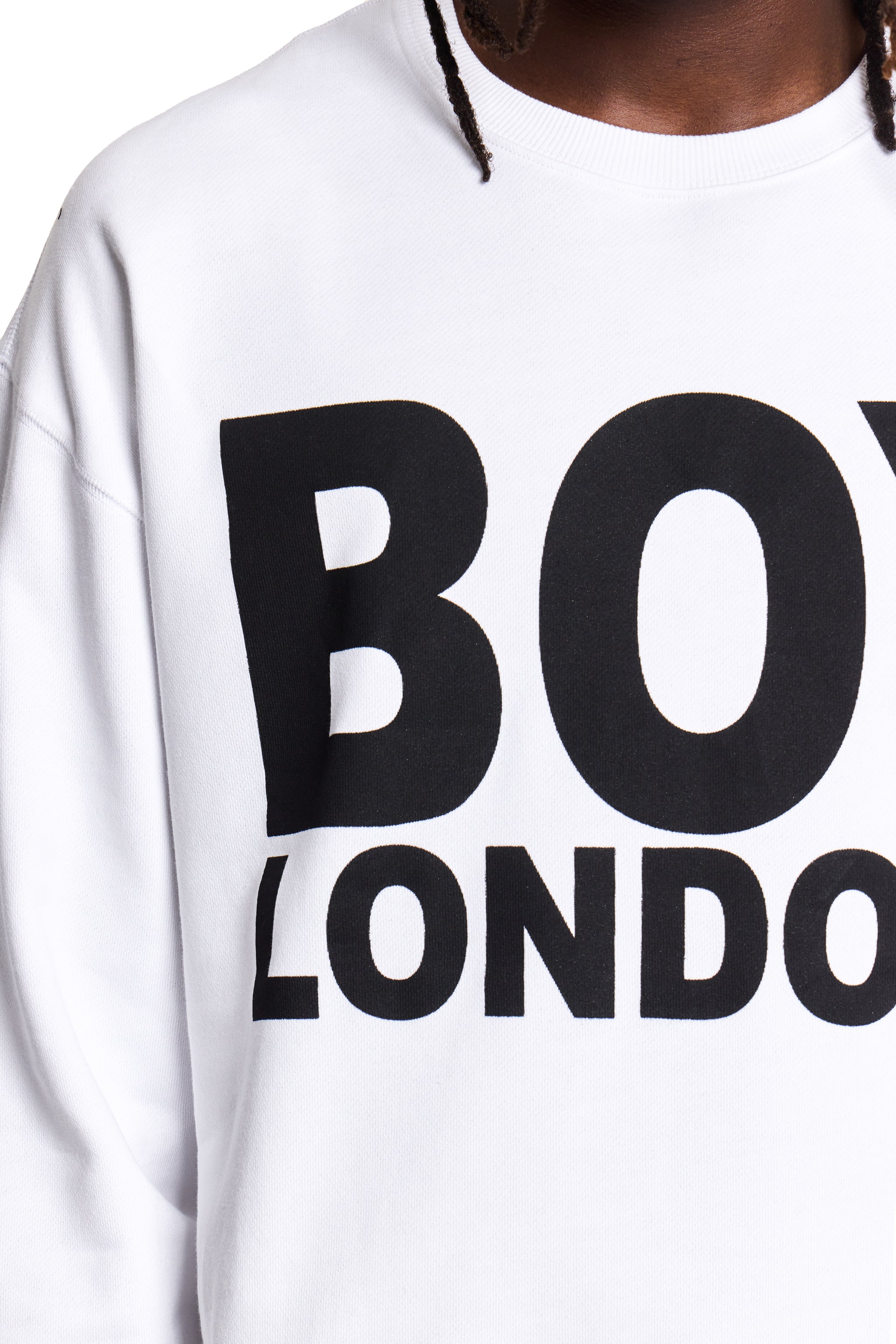 Model wearing White hoodie with 'BOY LONDON' text on a plain background